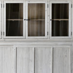 This Haley Cabinet has ample storage, with glass door panels opening to shelves and a bottom sliding door that opens to more shelves. Made from reclaimed pine with a white wash grey sealed finish, this brings an antique feel to any room. Reclaimed Pine White Wash Grey Sealed Finish Flat Glass Door Panels