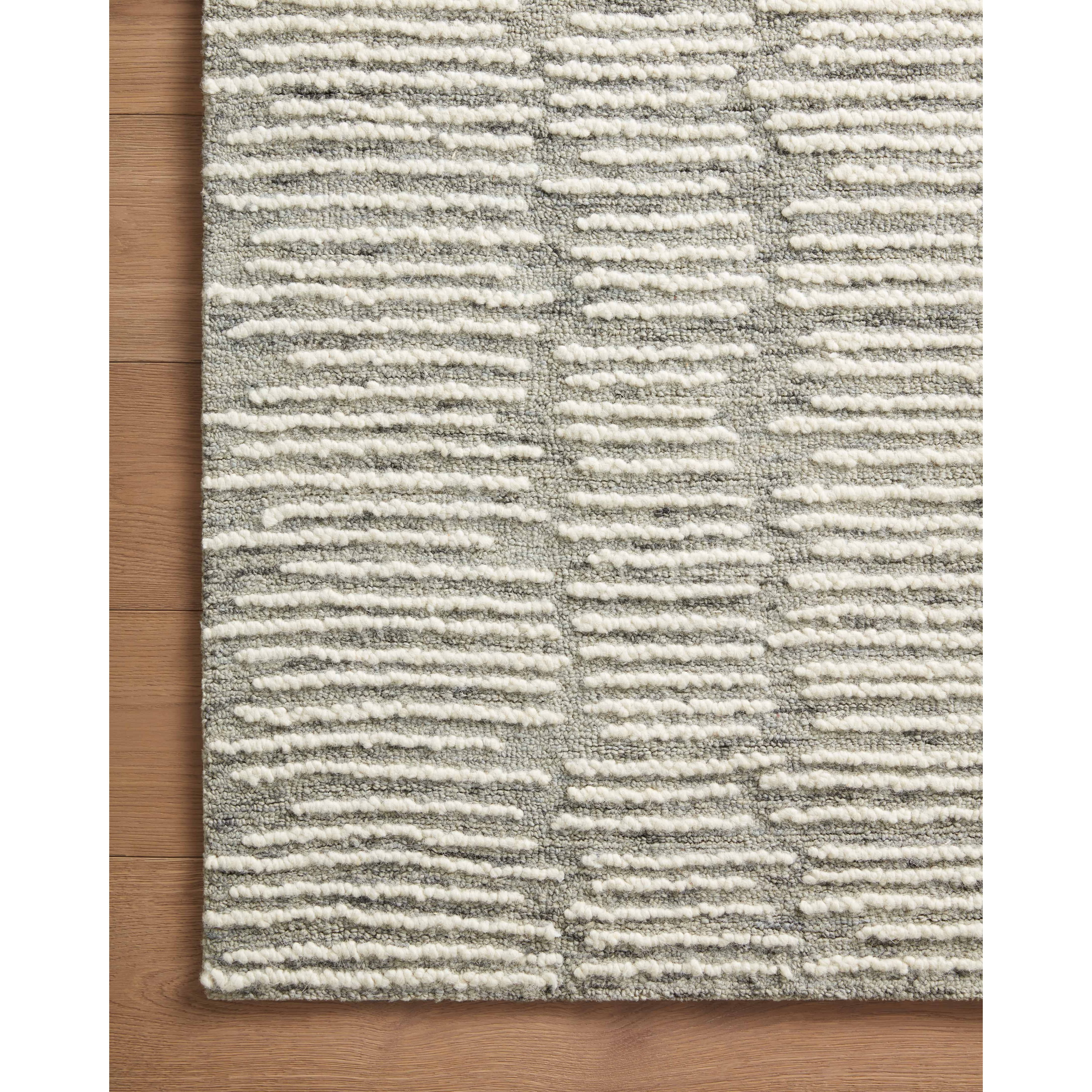 Hand-crafted with a combination of thick and fine yarns, the Tallulah Stone / Ivory Rug area rug creates dynamic dimension in living rooms, bedrooms, and more. The thicker yarns define the abstract, linear design, giving the rug a distinct high-low texture and sense of movement. Tallulah's soft, neutral palettes have a depth of tone inspired by watercolor pigmentation. Amethyst Home provides interior design, new construction, custom furniture, and area rugs in the Laguna Beach metro area.