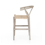 Modern curves redefine the classic wishbone-style counter stool. Vintage white all-weather wicker is woven for a dose of fresh texture within weathered grey teak framing. Cover or store indoors during inclement weather and when not in use.  Pictured in Weathered Grey. Also available in Black Teak and Matte Sealed Teak.  Overall Size: 21.50"w x 22.50"d x 38.50"h Seat Depth: 18.25" Seat Height: 26.50"