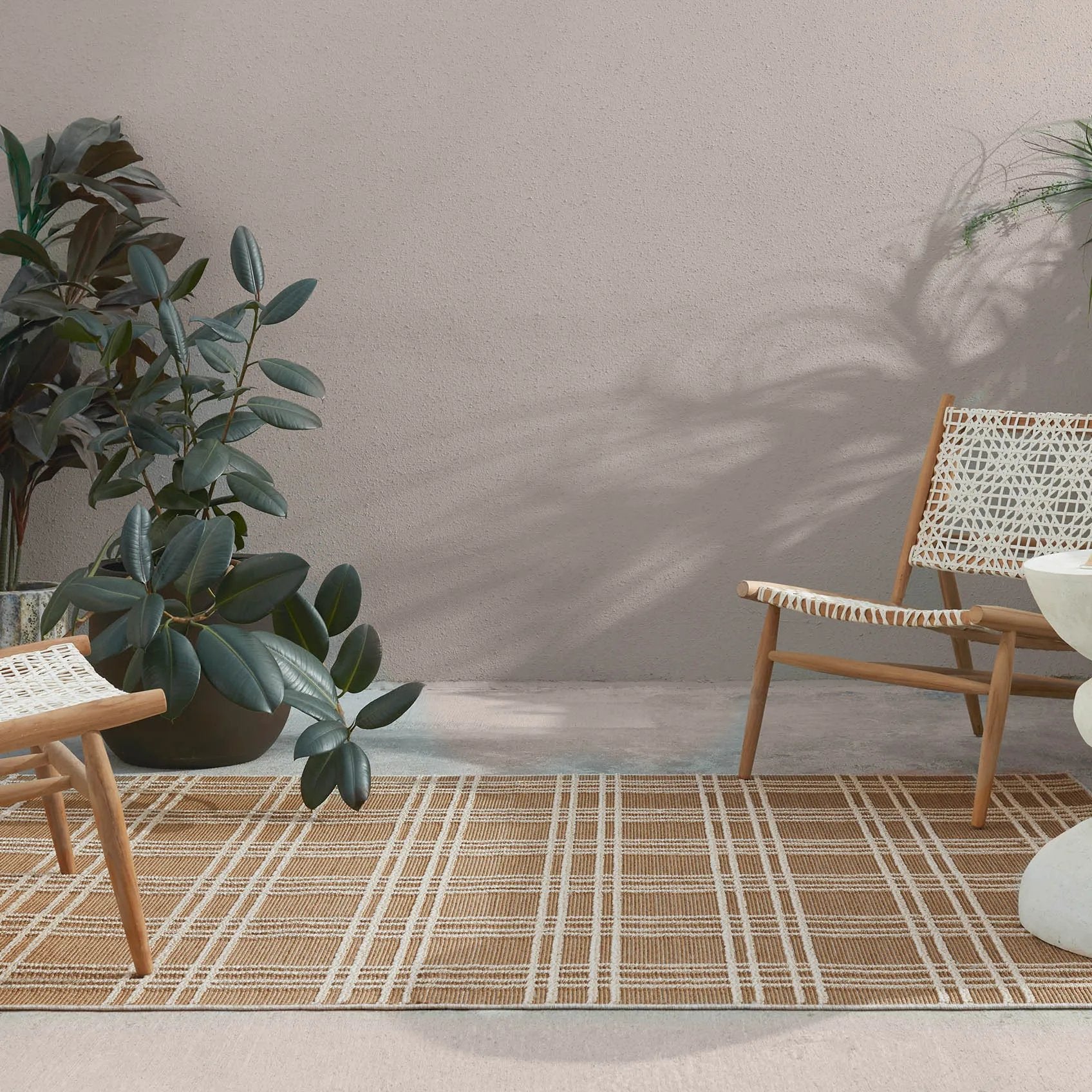 The indoor-outdoor Paradizo collection features durable, weather-resistant fibers that create a flatwoven, natural look. Emanating the colors and tone of grass fibers, the Barrett rug boasts a neutral, grounding palette. The textural grid design paired with the colorway of brown and cream highlight the easily styled nature of this accent piece. Amethyst Home provides interior design, new home construction design consulting, vintage area rugs, and lighting in the Nashville metro area.