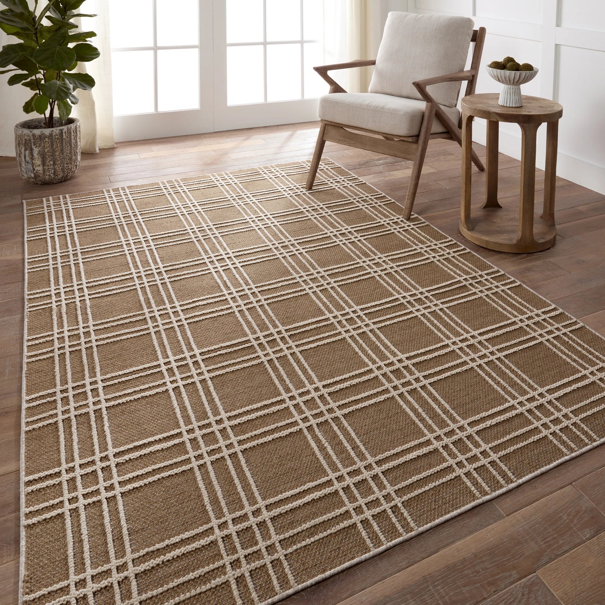 The indoor-outdoor Paradizo collection features durable, weather-resistant fibers that create a flatwoven, natural look. Emanating the colors and tone of grass fibers, the Barrett rug boasts a neutral, grounding palette. The textural grid design paired with the colorway of brown and cream highlight the easily styled nature of this accent piece. Amethyst Home provides interior design, new home construction design consulting, vintage area rugs, and lighting in the Seattle metro area.