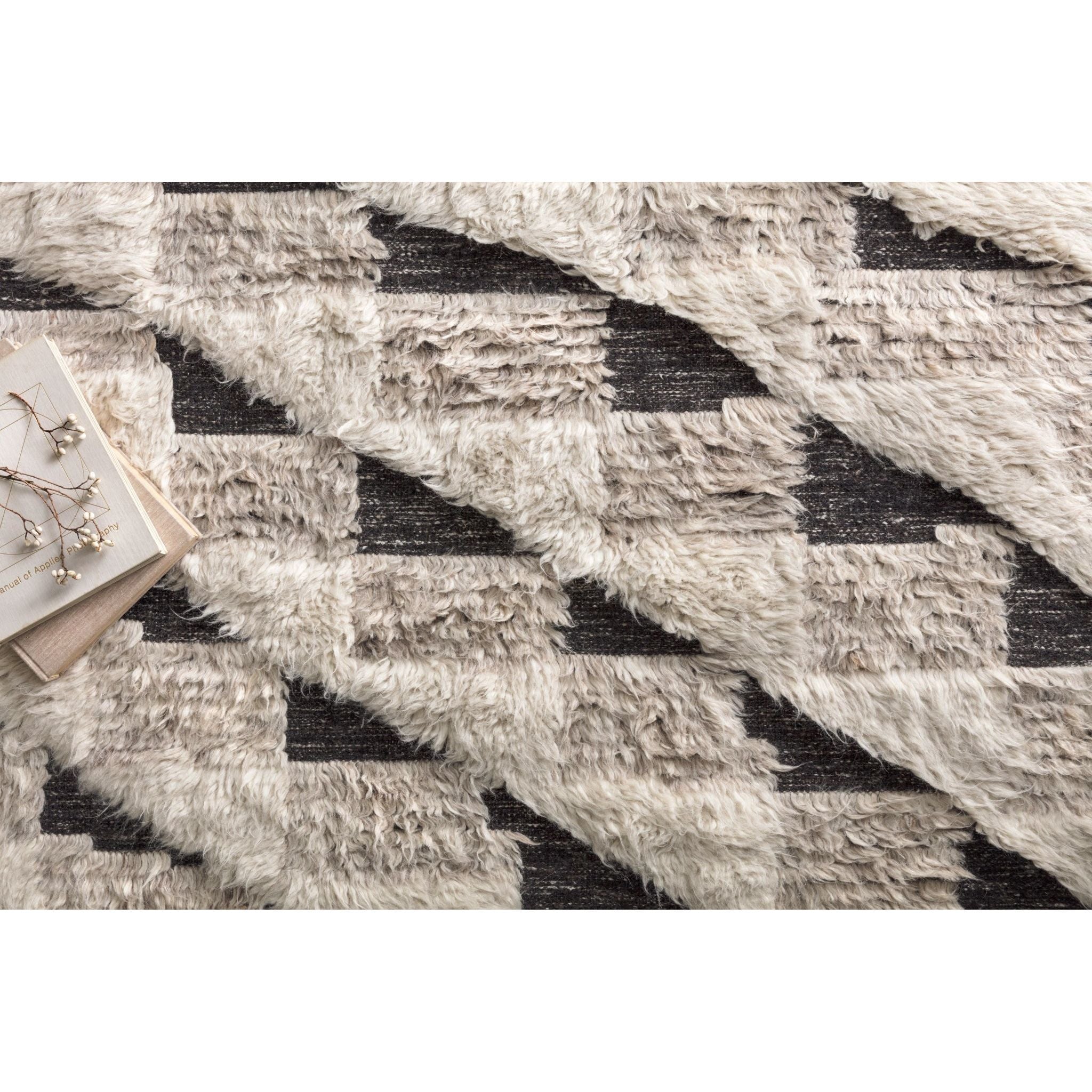 Khalid Natural/Black Rug - Amethyst Home A nod to timeless Moroccan style, the Khalid Collection is hand-knotted in India by skilled artisans. The soft pile features 100% natural, undyed wool, lending slight variations in tones that make each piece it's own. Plus, each rug is finished with a thoughtfully designed fringe.