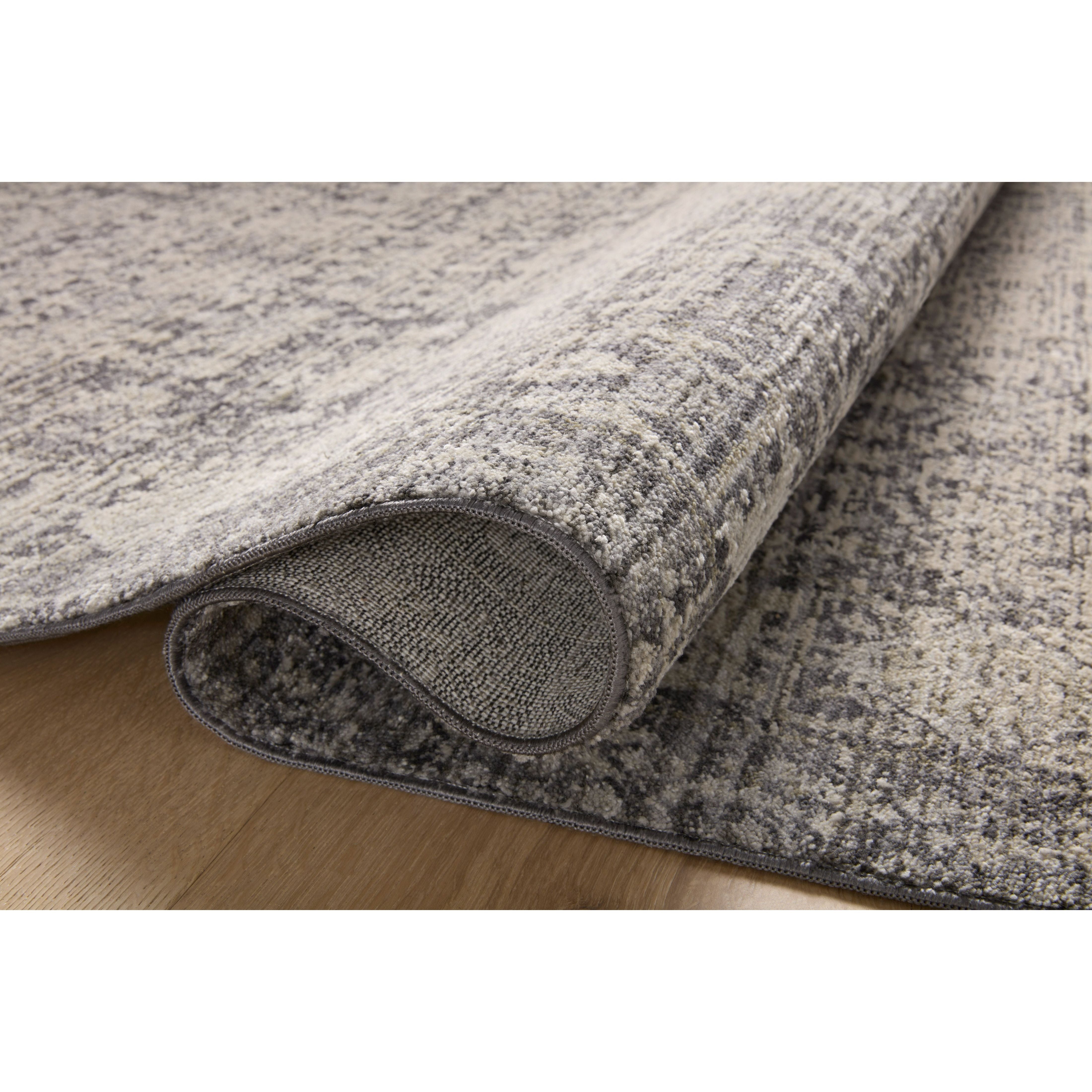 Amber Lewis x Loloi Alie Charcoal / Dove Rug have an elevated antique look and plush, modern feel. The rug’s underlying traditional motif is overlaid with a slightly higher pile that creates a softening effect like early morning fog. Amethyst Home provides interior design services, furniture, rugs, and lighting in the Miami metro area.