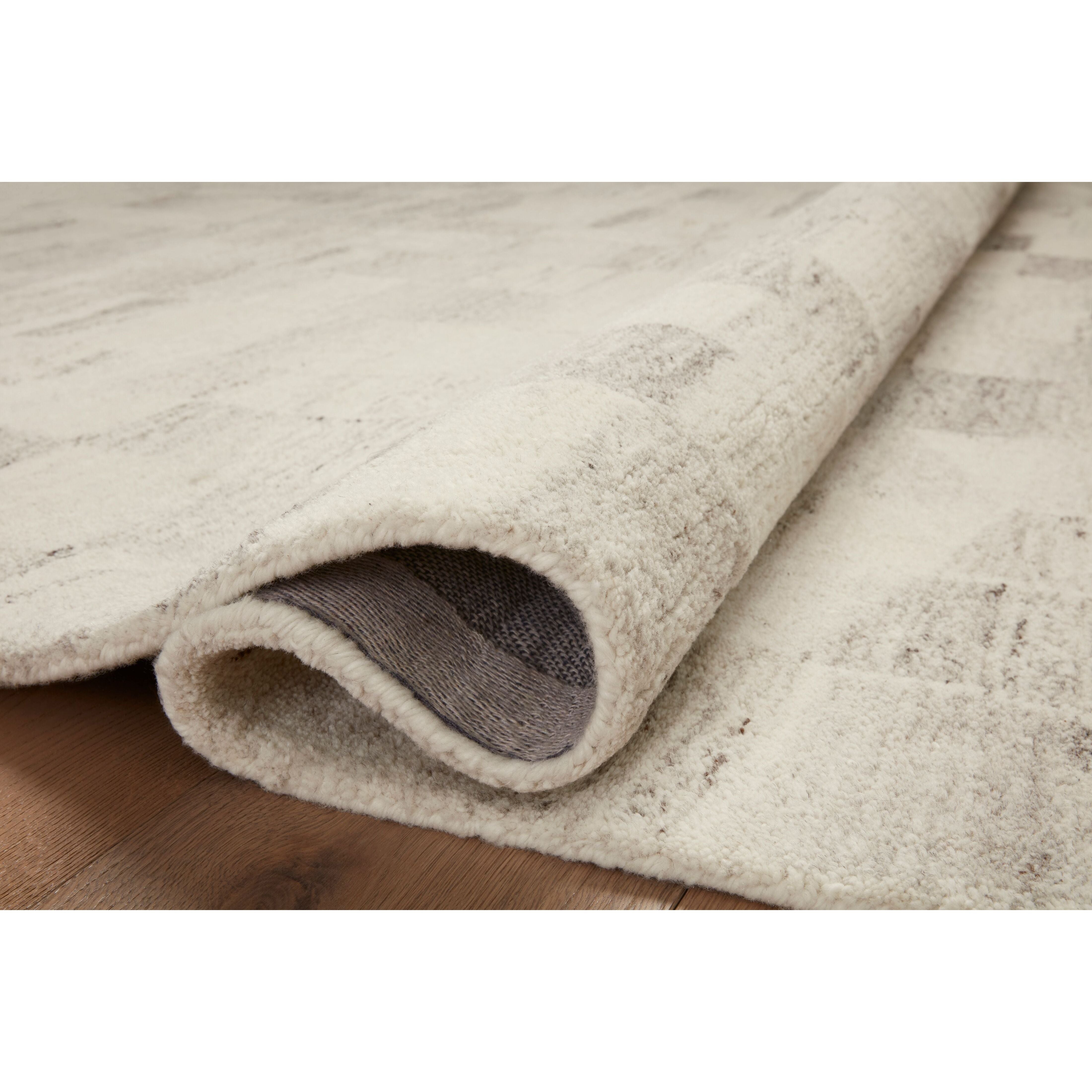 Featuring Amber Lewis x Loloi Rocky Ivory / Silver Rug by Loloi at Amethyst Home. The Rocky Collection area rug by Amber Lewis x Loloi is uniquely hand-tufted with undyed wool to create a subtle and natural color contrast. With a medium pile and neutral palette, the Rocky Collection can be a refreshing foundation in living rooms, bedrooms, and dens. The r. Amethyst Home provides interior design, new home construction design consulting, vintage area rugs, and lighting in the Kansas City metro area.