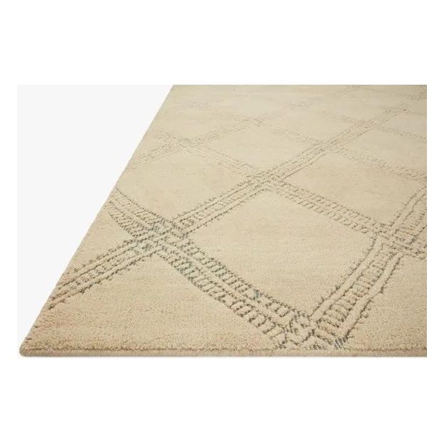 Featuring Carrier & Company x Loloi Milton Beige / Ocean Rug by Loloi at Amethyst Home. Made in collaboration with Carrier and Company x Loloi, the Milton Collection uses a banding detail to express the rich and plush pile. The addition of jute to the wool and cotton rugs creates a luxurious density that can be both seen and felt. As a simple border detail, a g. Amethyst Home provides interior design, new home construction design consulting, vintage area rugs, and lighting in the Miami metro area.