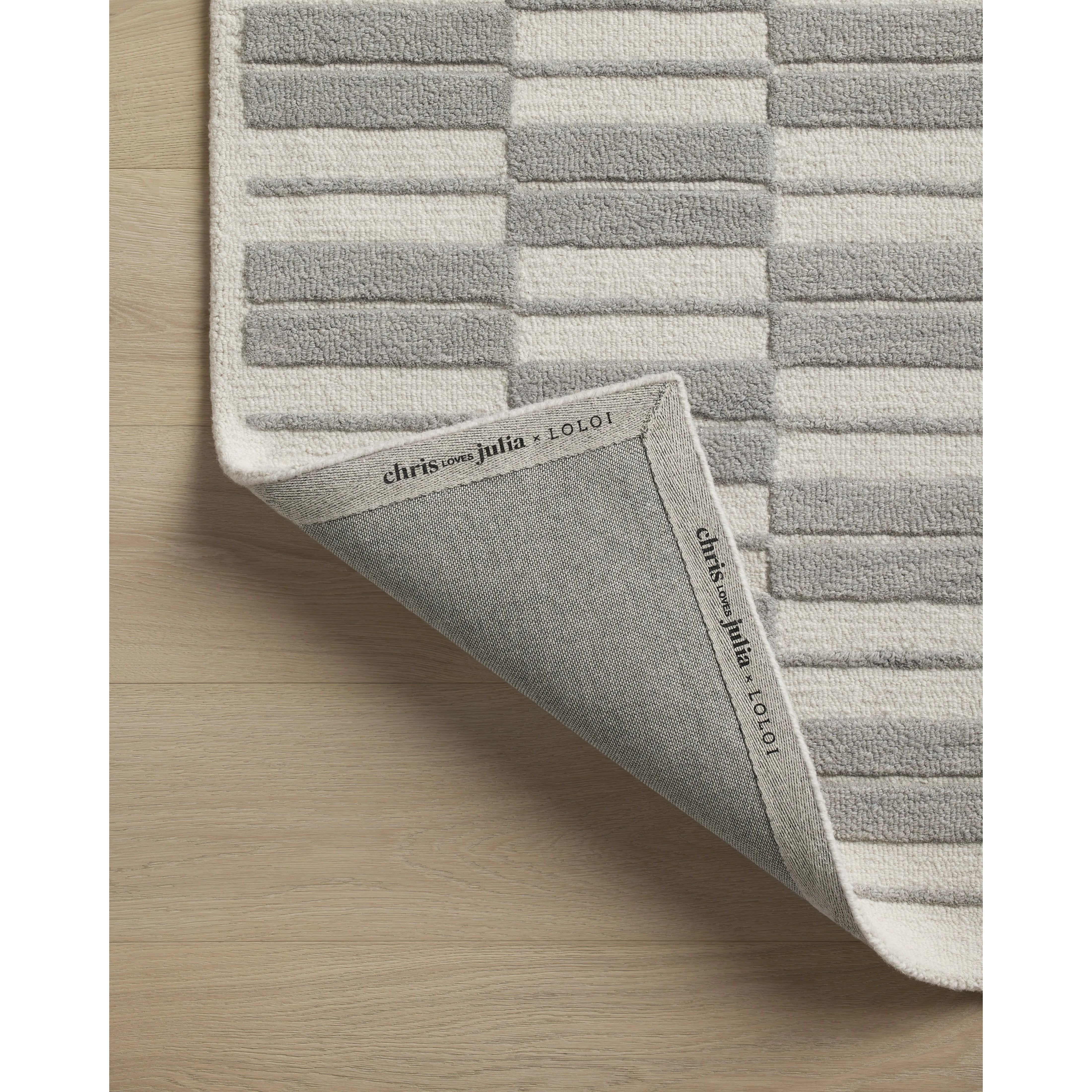 Featuring Chris Loves Julia x Loloi Bradley Ivory / Grey Rug by Loloi at Amethyst Home. The Bradley Collection from Chris Loves Julia x Loloi takes the classic striped rug to new heights. This hand-tufted, 100% wool collection features two-toned linear patterns with alternating high-low pile. Bradley is GoodWeave-certified, ensuring our commitment to ethic. Amethyst Home provides interior design, new home construction design consulting, vintage area rugs, and lighting in the Alpharetta metro area.