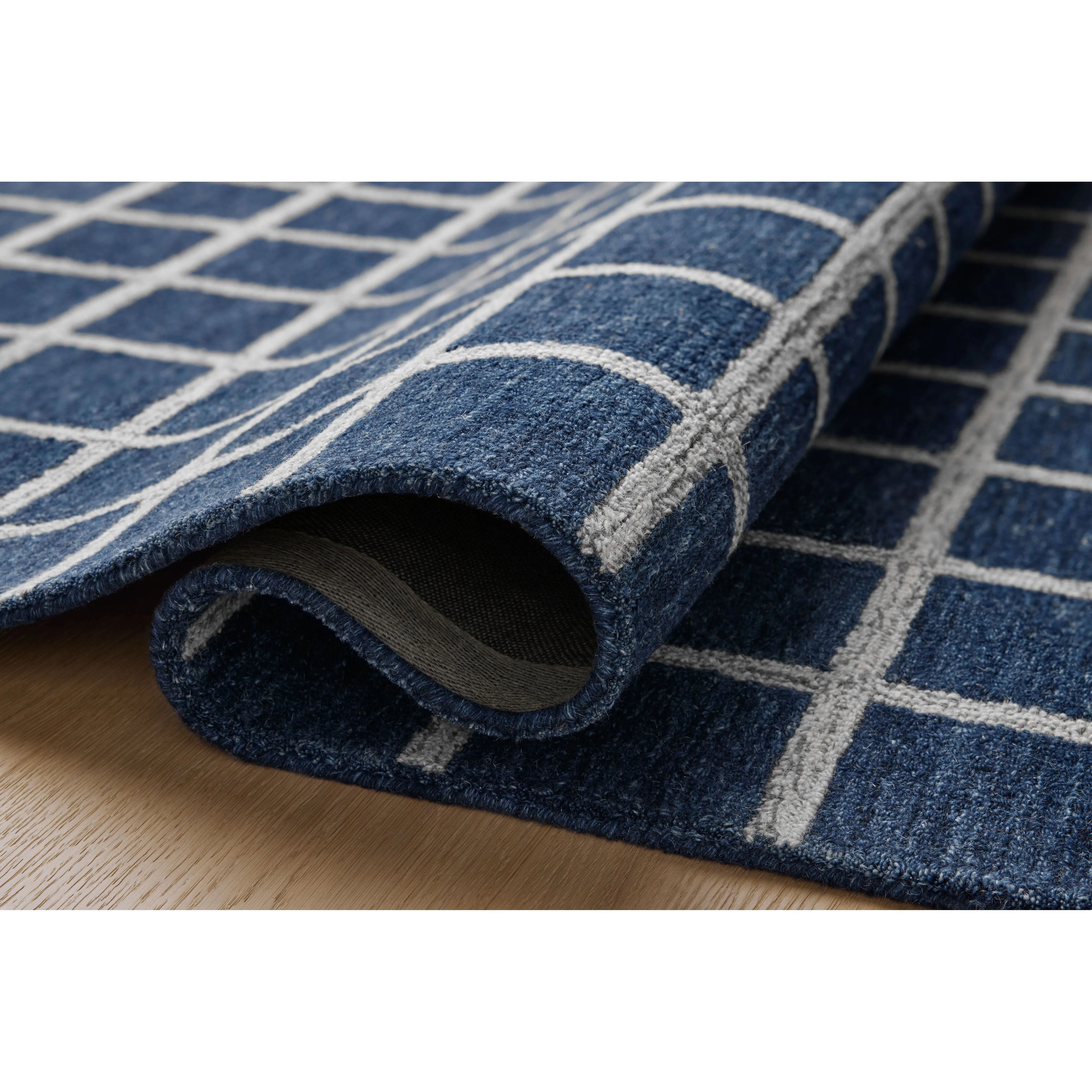 Featuring Chris Loves Julia x Loloi Polly Navy / Silver Rug by Loloi at Amethyst Home. Hand-tufted of wool and jute pile, the Polly collection for Chris Loves Julia x Loloi brings a fresh take on modern yet classic designs. With striking gridded designs toned down by a neutral color palette, Polly is a timeless choice for any room. Polly is also GoodWeave cert. Amethyst Home provides interior design, new home construction design consulting, vintage area rugs, and lighting in the Boston metro area.