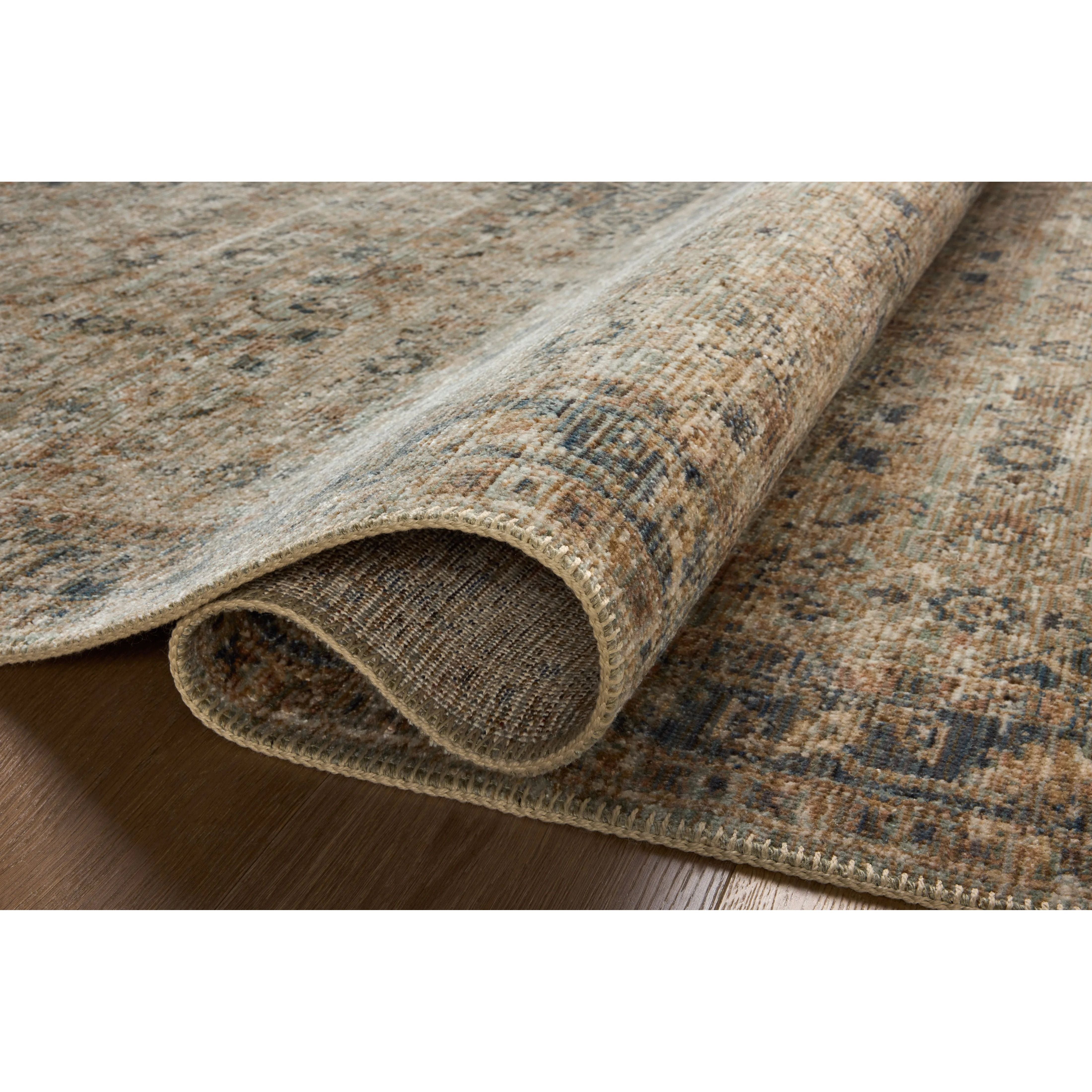 Featuring Heritage Sage / Navy Rug by Loloi at Amethyst Home. Heritage is Loloi’s best collection yet. Inspired by Amir Loloi’s favorite vintage rugs, the collection recreates a vintage aesthetic and variable-pile texture using a new craft process that was invented specifically for this rug—a process that took over two years to complete. Motifs in Heritage . Amethyst Home provides interior design, new home construction design consulting, vintage area rugs, and lighting in the Calabasas metro area.