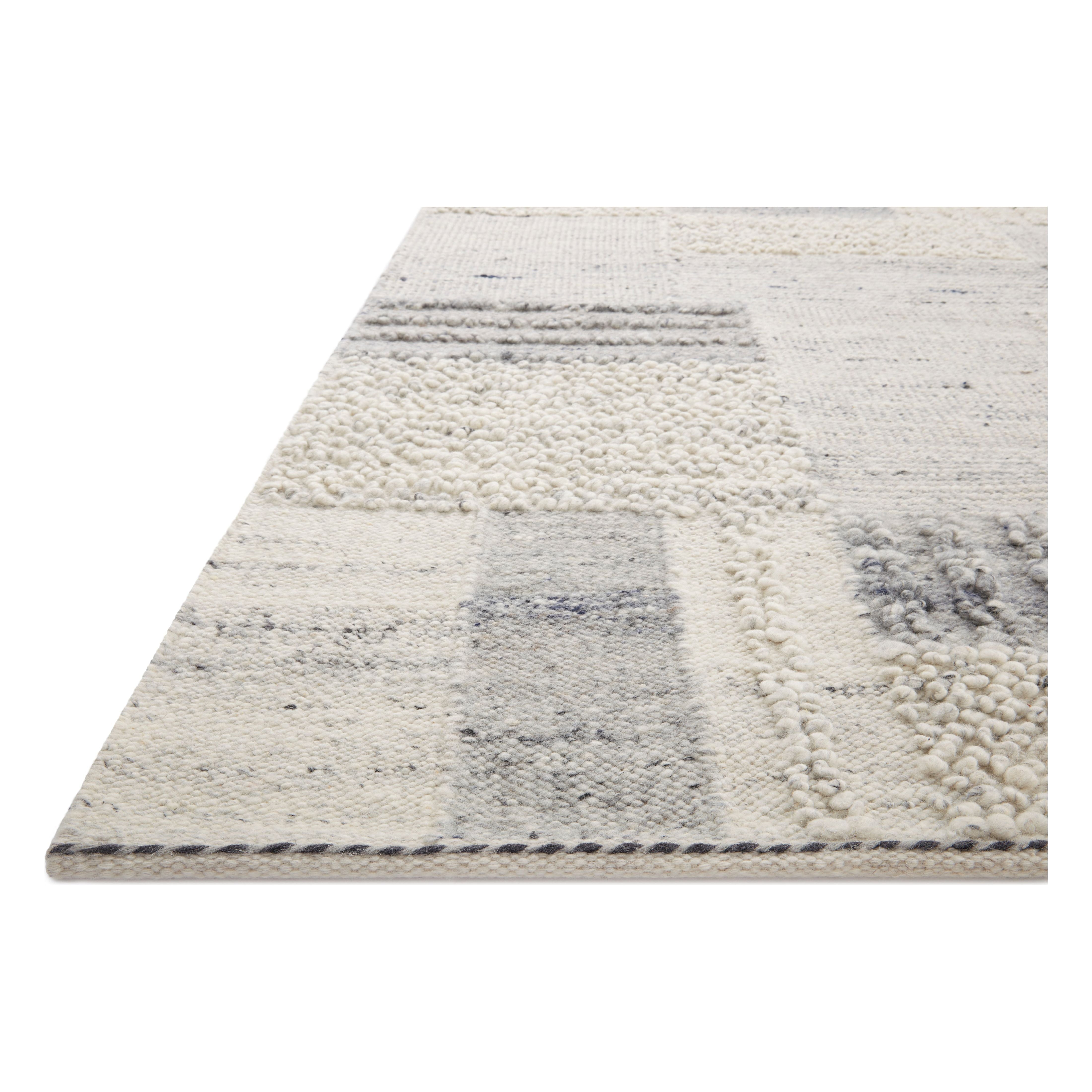 Featuring Manfred Slate / Mist Hand-Knotted Rug by Loloi at Amethyst Home. Each area rug in the Manfred Slate / Mist rug collection is meticulously hand-knotted with a technique that creates a high-low texture, adding visual depth and movement. The rug’s patchwork design is casually sophisticated, fitting into living rooms, bedrooms, and dens—anywhere a tou. Amethyst Home provides interior design, new home construction design consulting, vintage area rugs, and lighting in the Charlotte metro area.