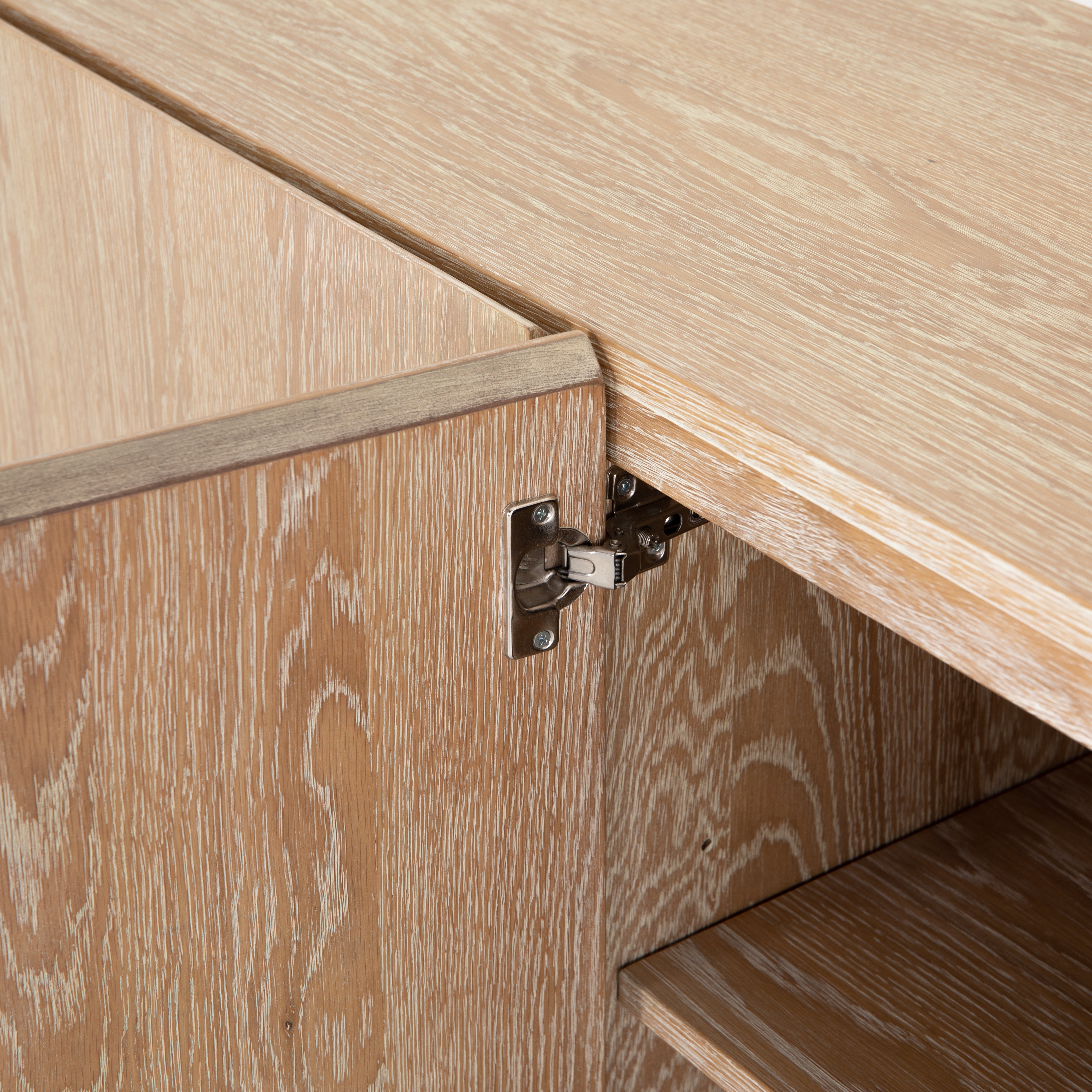 We love the grained matte finish on this Mika Washed Oak Veneer Dining Sideboard. The shelves make this the perfect sideboard for a functional, modernly attractive piece to add to your dining room  Size:  72.00"w x 16.00"d x 30.00"h Materials: Oak Veneer