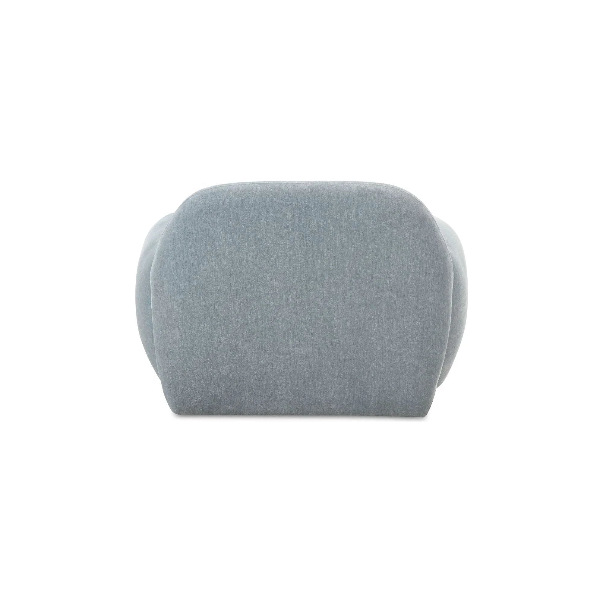 The Hazel lounge chair embraces minimalist, understated elegance with its low-profile, modernist silhouette. Wrapped in exaggerated  velvet fabric, it offers a distinct tactility and comfort. The bold, curved arm design makes a stylish statement, harmonizing with the sleek form to create an inviting focal point in any setting Amethyst Home provides interior design, new home construction design consulting, vintage area rugs, and lighting in the Nashville metro area.