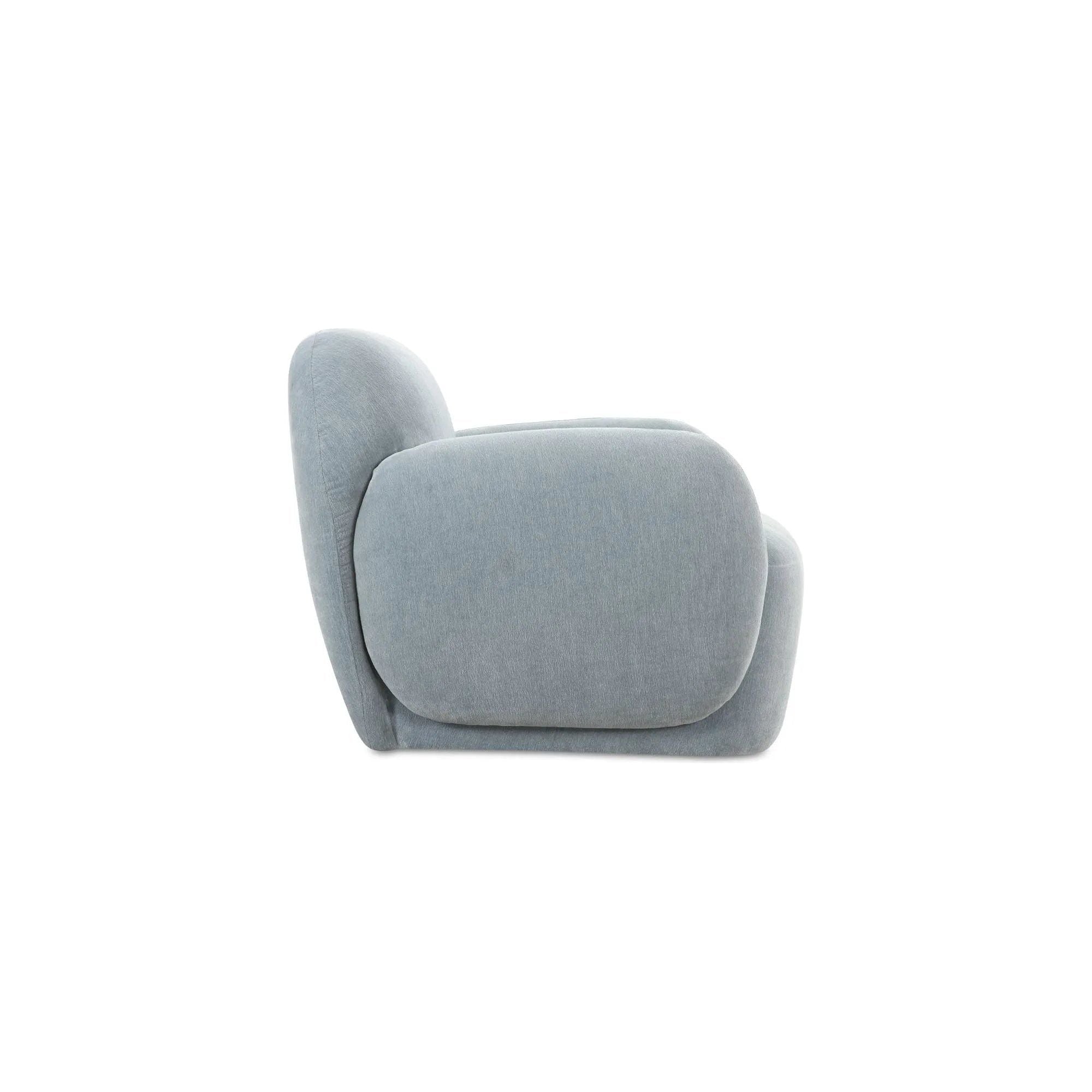 The Hazel lounge chair embraces minimalist, understated elegance with its low-profile, modernist silhouette. Wrapped in exaggerated  velvet fabric, it offers a distinct tactility and comfort. The bold, curved arm design makes a stylish statement, harmonizing with the sleek form to create an inviting focal point in any setting Amethyst Home provides interior design, new home construction design consulting, vintage area rugs, and lighting in the Seattle metro area.
