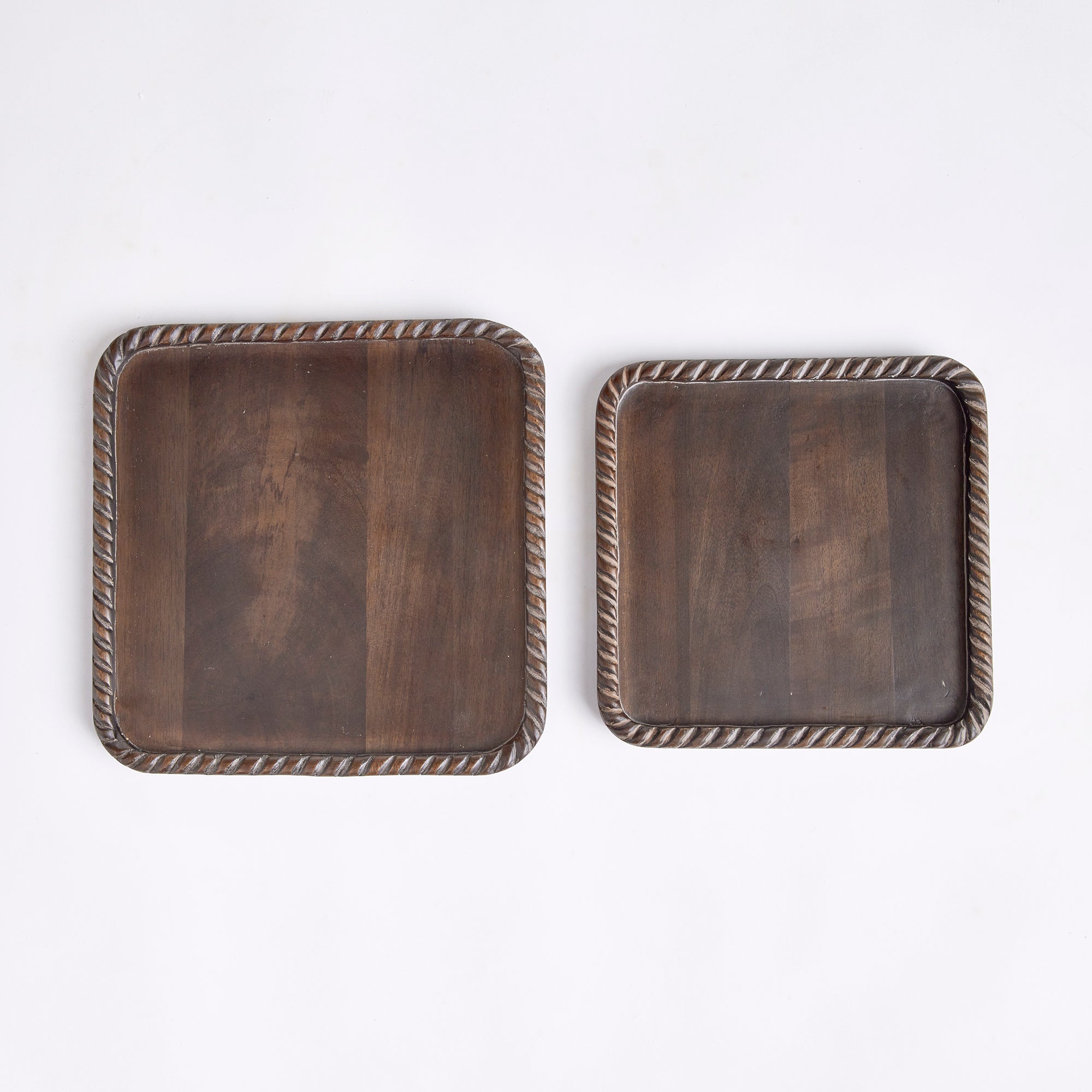 Hand carved from mango wood, this pair of trays is a sweet little accent for baked goods or a cheese tray. A little touch of natural wood tone is always on trend. Amethyst Home provides interior design, new construction, custom furniture, and area rugs in the Park City metro area.