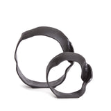 A matte black finish and rough, organic repeated circular shapes make these cast aluminum sculptures unique. A  contemporary touch for home office or den on book shelf, mantle or console. Amethyst Home provides interior design, new construction, custom furniture, and area rugs in the Laguna Beach metro area.