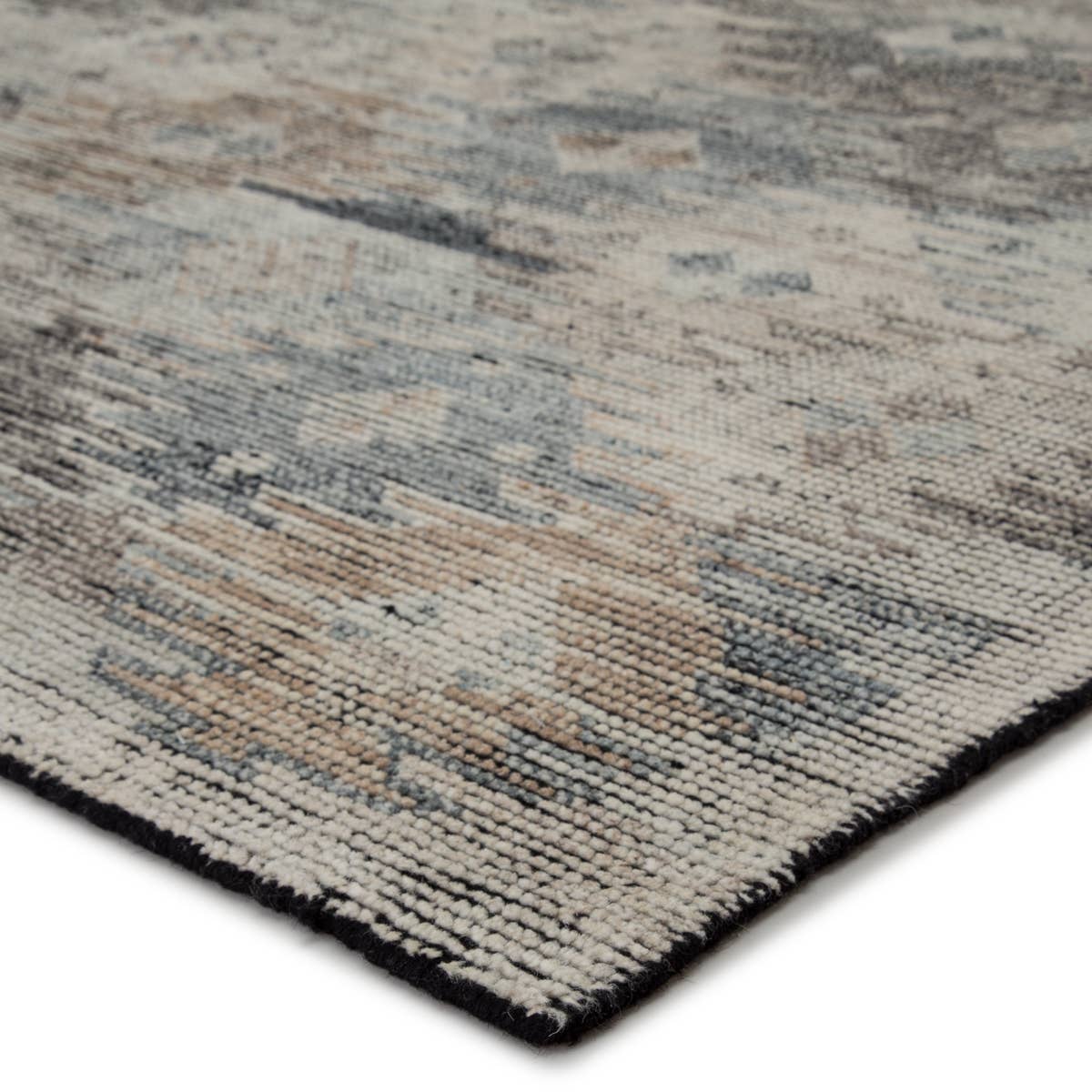 The Jaipur Living Rize Nakoda Area Rug, or RIZ 08, has a dynamic tribal motif that creates an all-over design on the artistically distressed Nakoda area rug. In a black, tan, white, and blue colorway, this durable hand-knotted wool rug is a gorgeous choice for any living room, bedroom, or other high traffic area. 