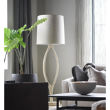 The Urbino Ash Floor Lamp is crafted from sustainably harvested hardwood by Verellen in North Carolina. The unique shape of the body paired with the oatmeal shade complements any room Amethyst Home provides interior design, new home construction design consulting, vintage area rugs, and lighting in the Salt Lake City metro area.