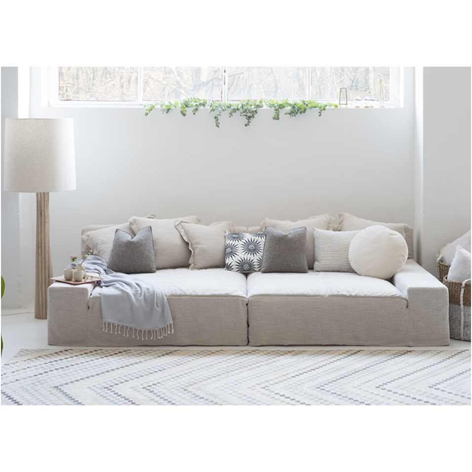 The ultimate low, cozy sofa. We would put this Esme sofa from Verellen in the family room, living room, or movie theater. The juxtaposition of a juicy, miniature-spring filled down-wrapped cushion and firm back is ultra comfortable. We love the thick, firm arms for resting cell phones & snacks. Enjoy this sofa upholstered or slipcovered.