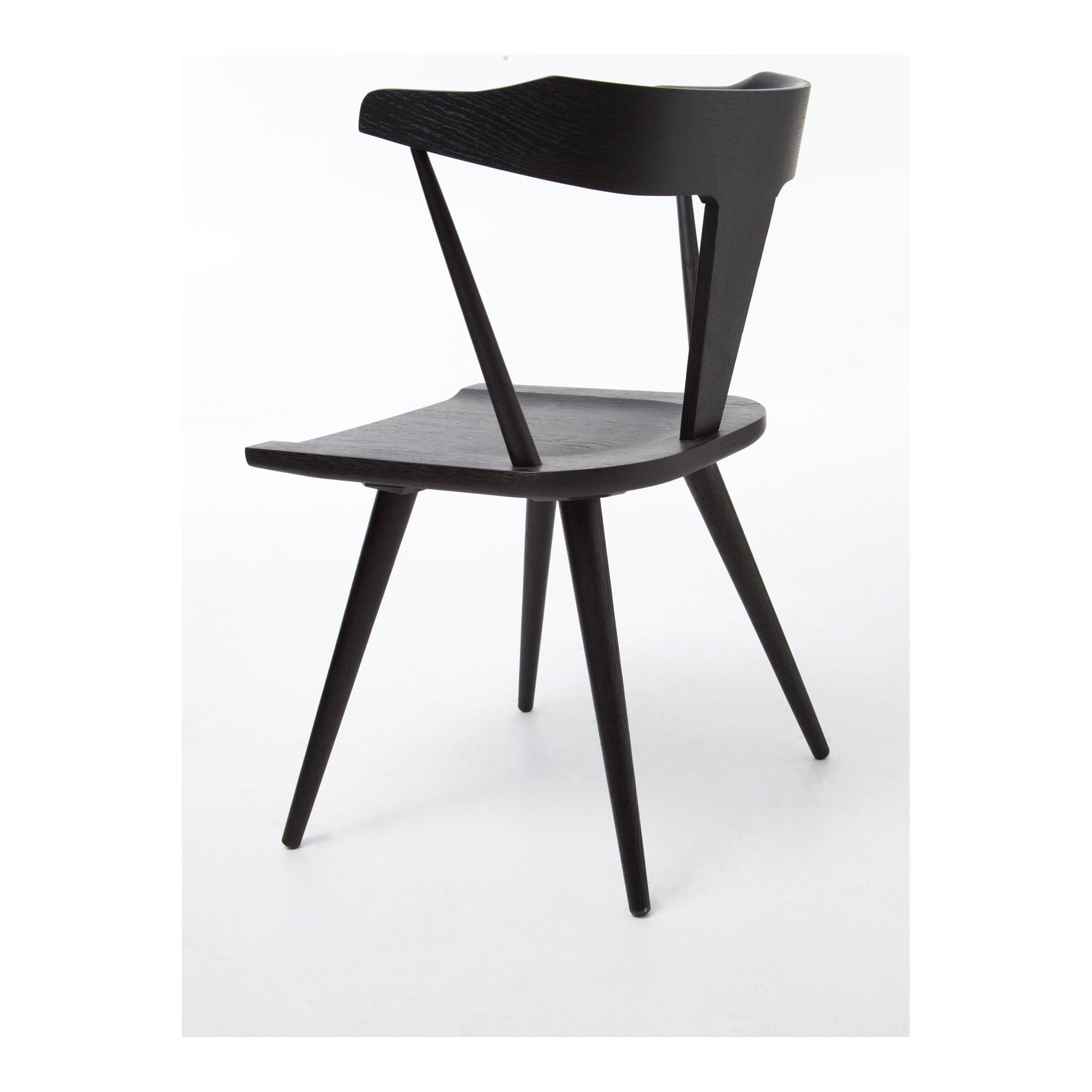 Featuring Ripley Black Dining Chair by Four Hands at Amethyst Home. This new take on the mid-century Windsor chair, the Ripley Dining Chair has a bowed, sculptural silhouette. A soft black finish adds movement to the wood by highlighting the natural grain of weathered oak. The chair is perfect for the chic, modern dining room look or that special nook in you.  Amethyst Home provides interior design, new home construction design consulting, vintage area rugs, and lighting in the Houston metro area.