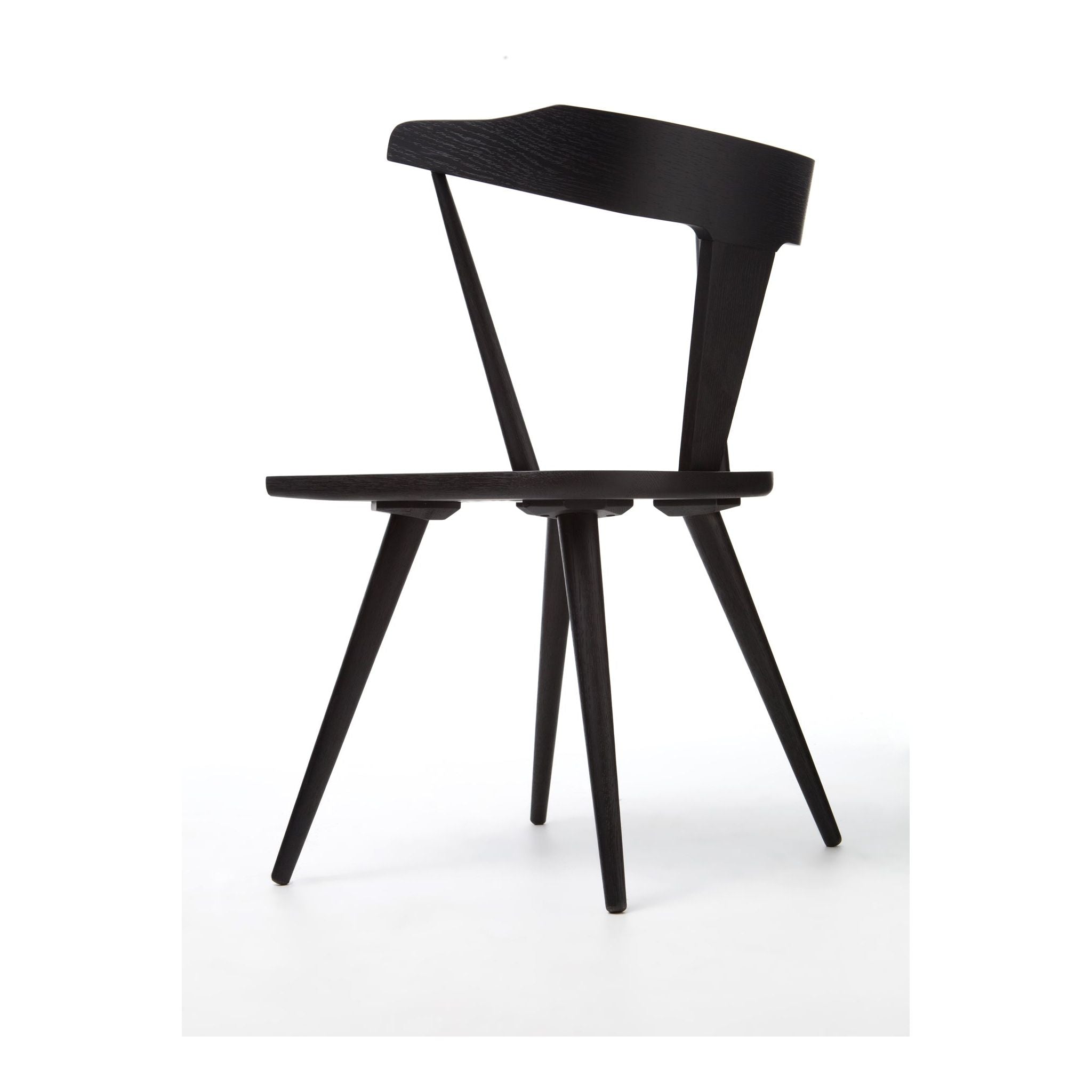 Featuring Ripley Black Dining Chair by Four Hands at Amethyst Home. This new take on the mid-century Windsor chair, the Ripley Dining Chair has a bowed, sculptural silhouette. A soft black finish adds movement to the wood by highlighting the natural grain of weathered oak. The chair is perfect for the chic, modern dining room look or that special nook in y.  Amethyst Home provides interior design, new home construction design consulting, vintage area rugs, and lighting in the Charlotte metro area.