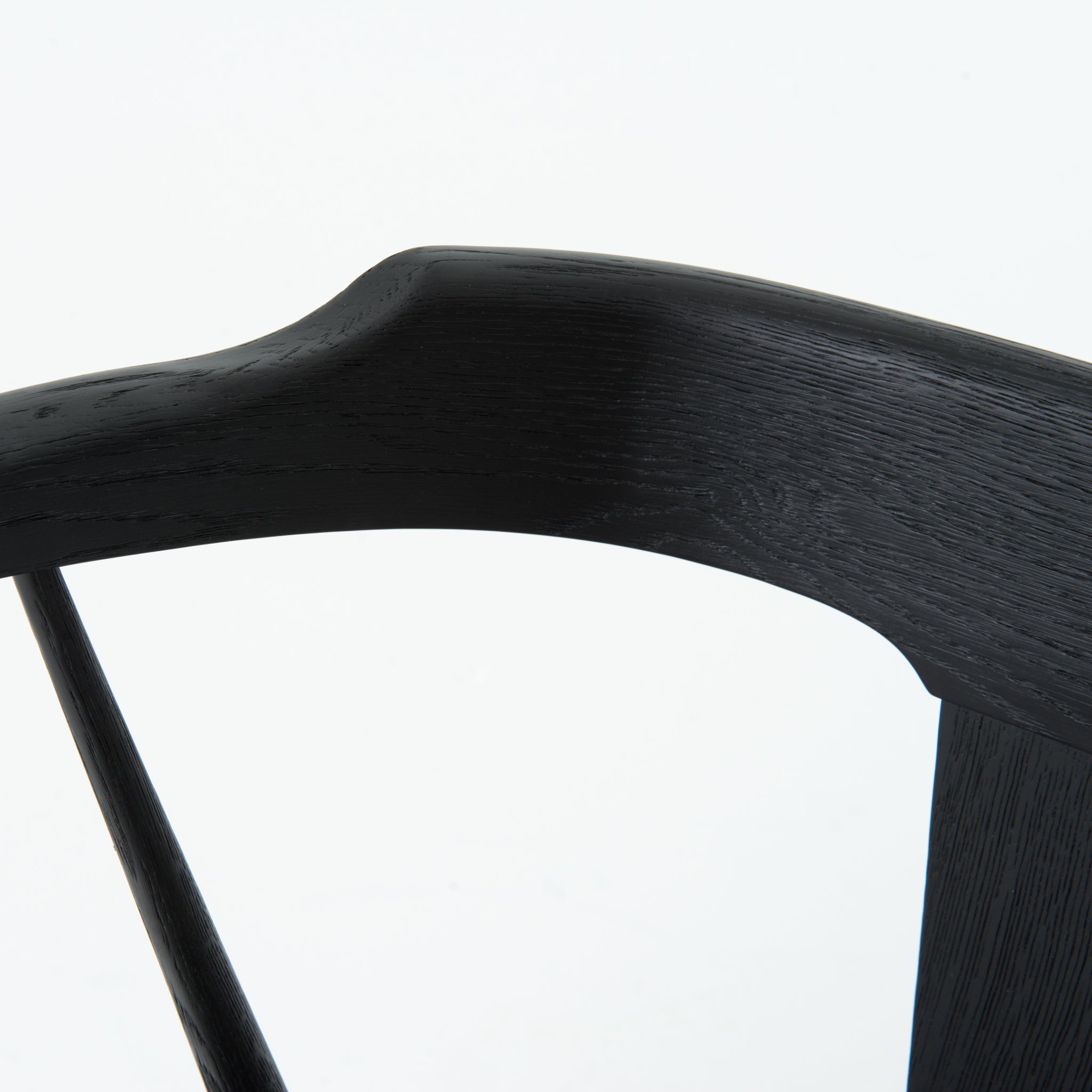 This new take on the mid-century Windsor chair, the Ripley Dining Chair has a bowed, sculptural silhouette. A soft black finish adds movement to the wood by highlighting the natural grain of weathered oak. The chair is perfect for the chic, modern dining room look.