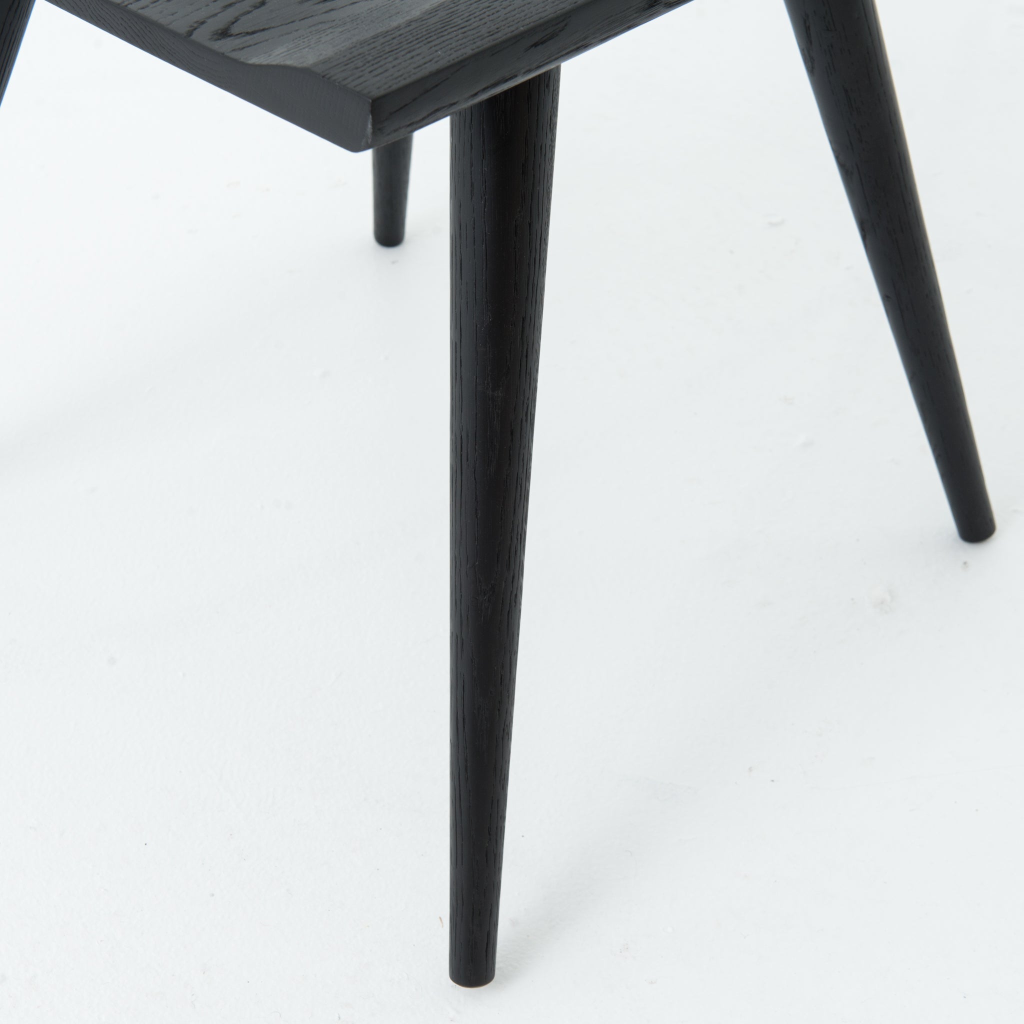 Featuring Ripley Black Dining Chair by Four Hands at Amethyst Home. This new take on the mid-century Windsor chair, the Ripley Dining Chair has a bowed, sculptural silhouette. A soft black finish adds movement to the wood by highlighting the natural grain of weathered oak. The chair is perfect for the chic, modern dining room look or that special nook in y.  Amethyst Home provides interior design, new home construction design consulting, vintage area rugs, and lighting in the San Diego metro area.