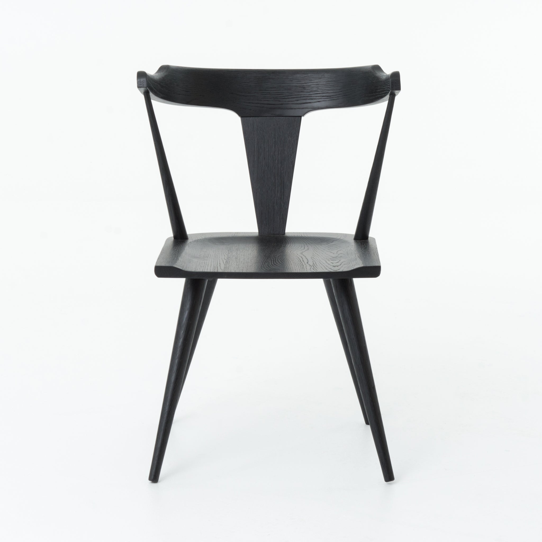 This new take on the mid-century Windsor chair, the Ripley Dining Chair has a bowed, sculptural silhouette. A soft black finish adds movement to the wood by highlighting the natural grain of weathered oak. The chair is perfect for the chic, modern dining room look.