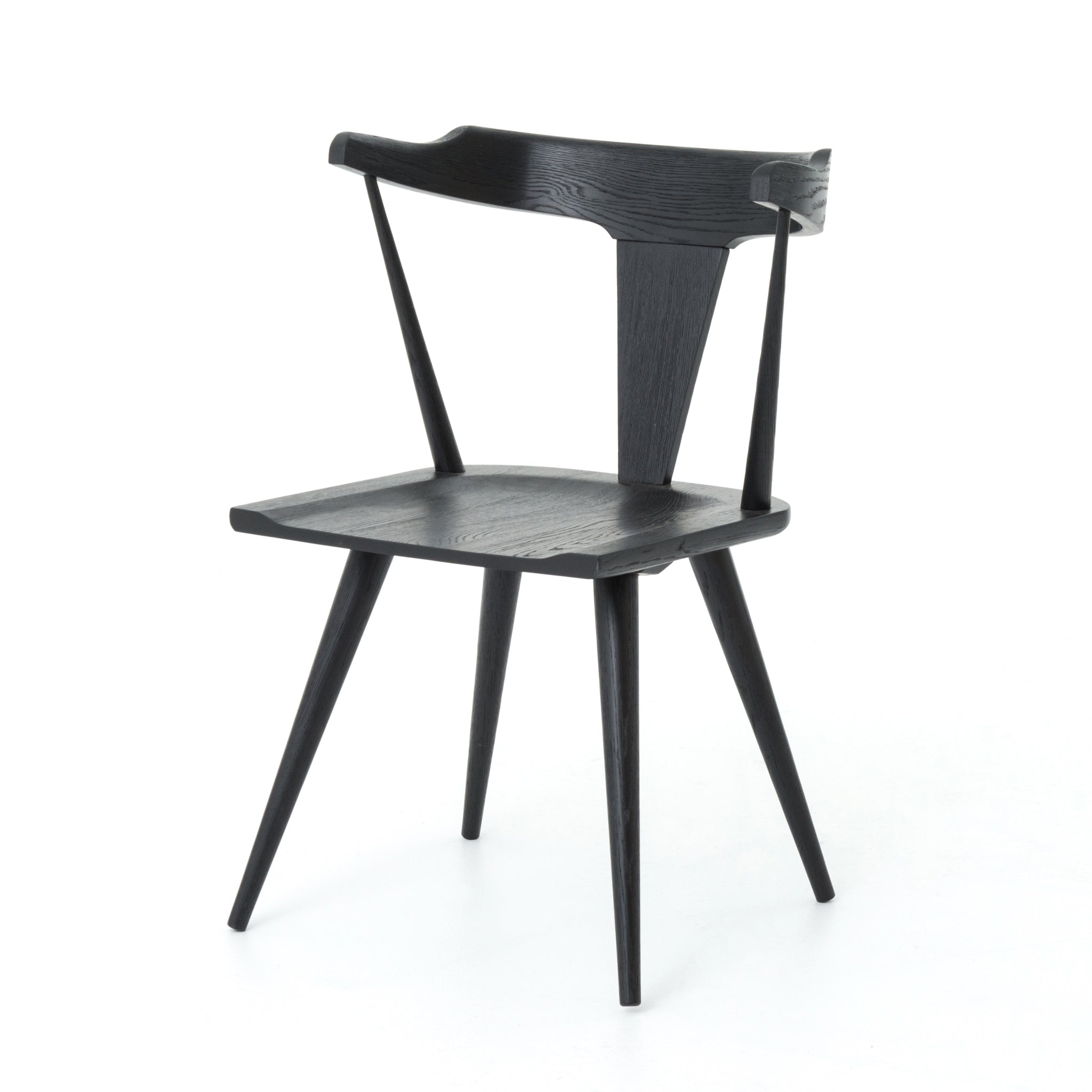 Featuring Ripley Black Dining Chair by Four Hands at Amethyst Home. This new take on the mid-century Windsor chair, the Ripley Dining Chair has a bowed, sculptural silhouette. A soft black finish adds movement to the wood by highlighting the natural grain of weathered oak. The chair is perfect for the chic, modern dining room look or that special nook in your.  Amethyst Home provides interior design, new home construction design consulting, vintage area rugs, and lighting in the Austin metro area.
