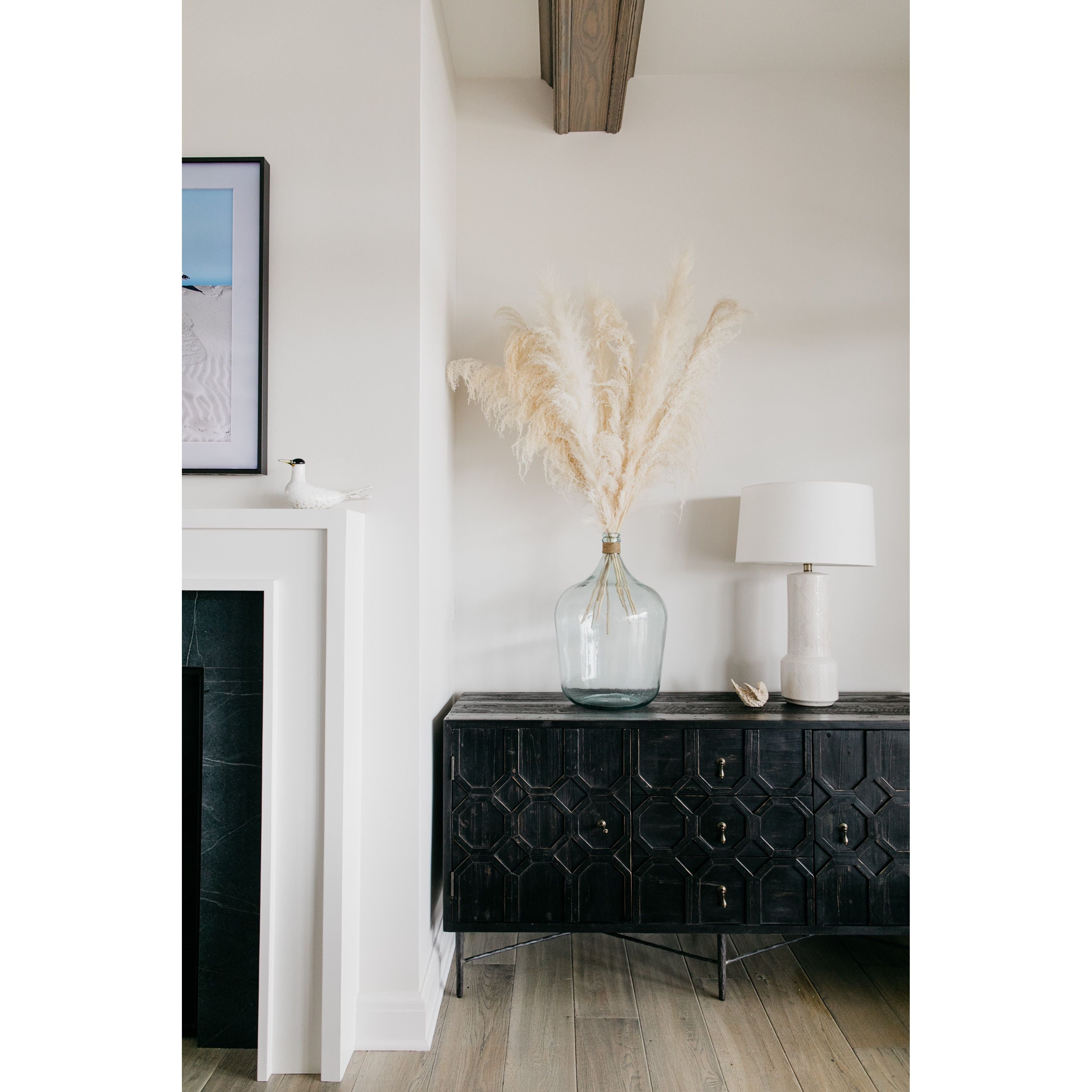 The Harten cabinet is beautifully crafted of black stained pine.  Its versatile cabinet drawer combo is perfect for both media and dining room storage.  Size: 63"l x 20"d x 31"h  Finish may vary slightly by piece as this is a hand-crafted product.  Please allow 3-5 weeks for shipping.