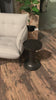 Made from raw black cast aluminum, a dramatically tapered Gino End Table - Raw Black flaunts beautiful high/ low hues and subtle Brutalist vibes. Perfect for setting your book or favorite drink next to.   Overall Dimensions: 13.00"w x 13.00"d x 20.00"h