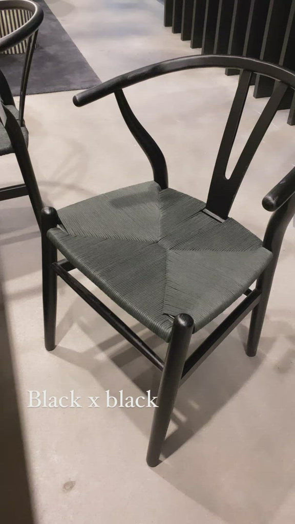 We loved the curved back and woven fibre seat of this Ventana Black Dining Chair. Simple and sturdy, this is an easy choice for your dining room.   Size: 19.5"W x 16.5"D x 31"H Seat Height: 18.11" Materials: Solid Elm Frame, Woven Fibre Seat   
