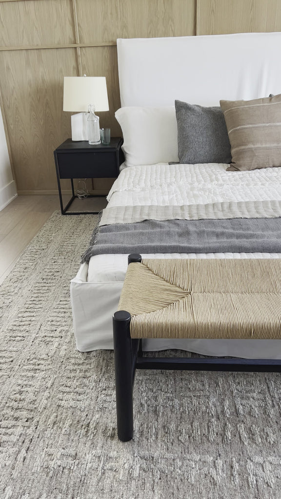 Cisco Brothers April Bed is designed and constructed in Los Angeles. The pinched edges and clean lines bring a modern, minimalist feel to any bedroom. Photographed in White Denim and Bengal Pin Striped Indigo. Amethyst Home provides interior design, new home construction design consulting, vintage area rugs, and lighting in the Scottsdale metro area.