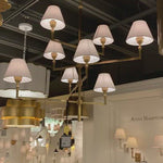 The gorgeous layers of linen shades on this Jane Large Offset Chandelier by Visual Comfort make it a classic, elegant piece to add to any living room, dining room, or other large area.   Designer: Alexa Hampton