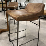Upgrade your kitchen or dining room with this sleek, cocktail-ready Starlet Counter + Bar Stool - Open Road Brown Leather that showcases poise and comfort. This adds a cool sophistication to your space with its slim iron frame and luxe leather upholstery. 