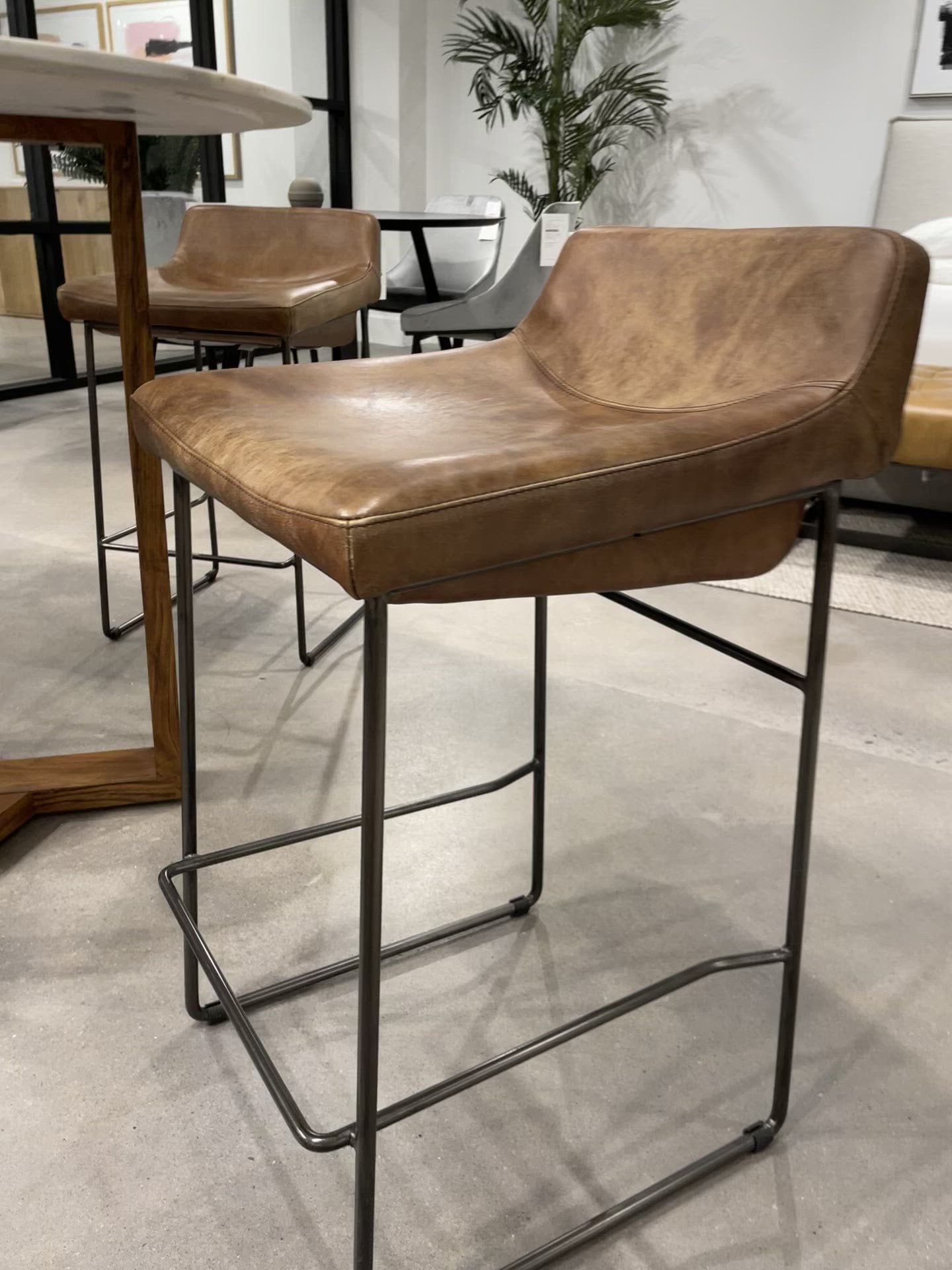 Upgrade your kitchen or dining room with this sleek, cocktail-ready Starlet Counter + Bar Stool - Open Road Brown Leather that showcases poise and comfort. This adds a cool sophistication to your space with its slim iron frame and luxe leather upholstery. 