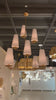 We love the textured look of the Fontaine Vertical Chandelier by Visual Comfort. The layered linen shades brings a classy, warm look to any living room, dining room, or other large area.   Designer: AERIN