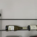 Store – and sip – in style. Tall, wall-mountable iron wine rack is finished in gunmetal, with open shelving for proper storage and stylish display of favorite wines. Anchors included.  Size: 32" w x 5.75" d x 72" h