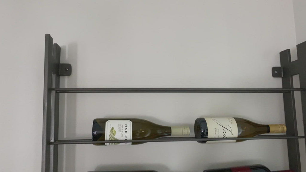 Store – and sip – in style. Tall, wall-mountable iron wine rack is finished in gunmetal, with open shelving for proper storage and stylish display of favorite wines. Anchors included.  Size: 32" w x 5.75" d x 72" h