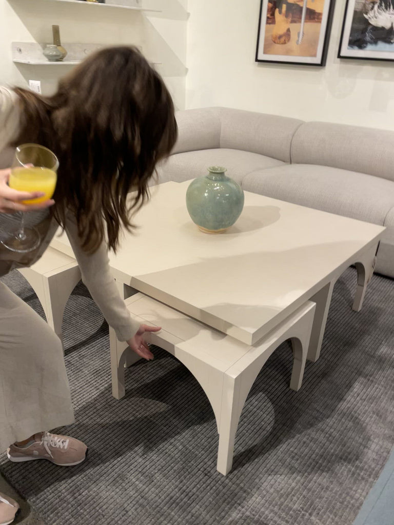 Meet a forward-thinking oak coffee table as stylish as it is functional with this Amara Coffee Table. We love the beautifully arched sides with four separate nesting tables that slide out to create ample extra surfaces as needed, tucking back under with ease.  Overall Dimensions: 47.25"w x 47.25"d x 18.00"h