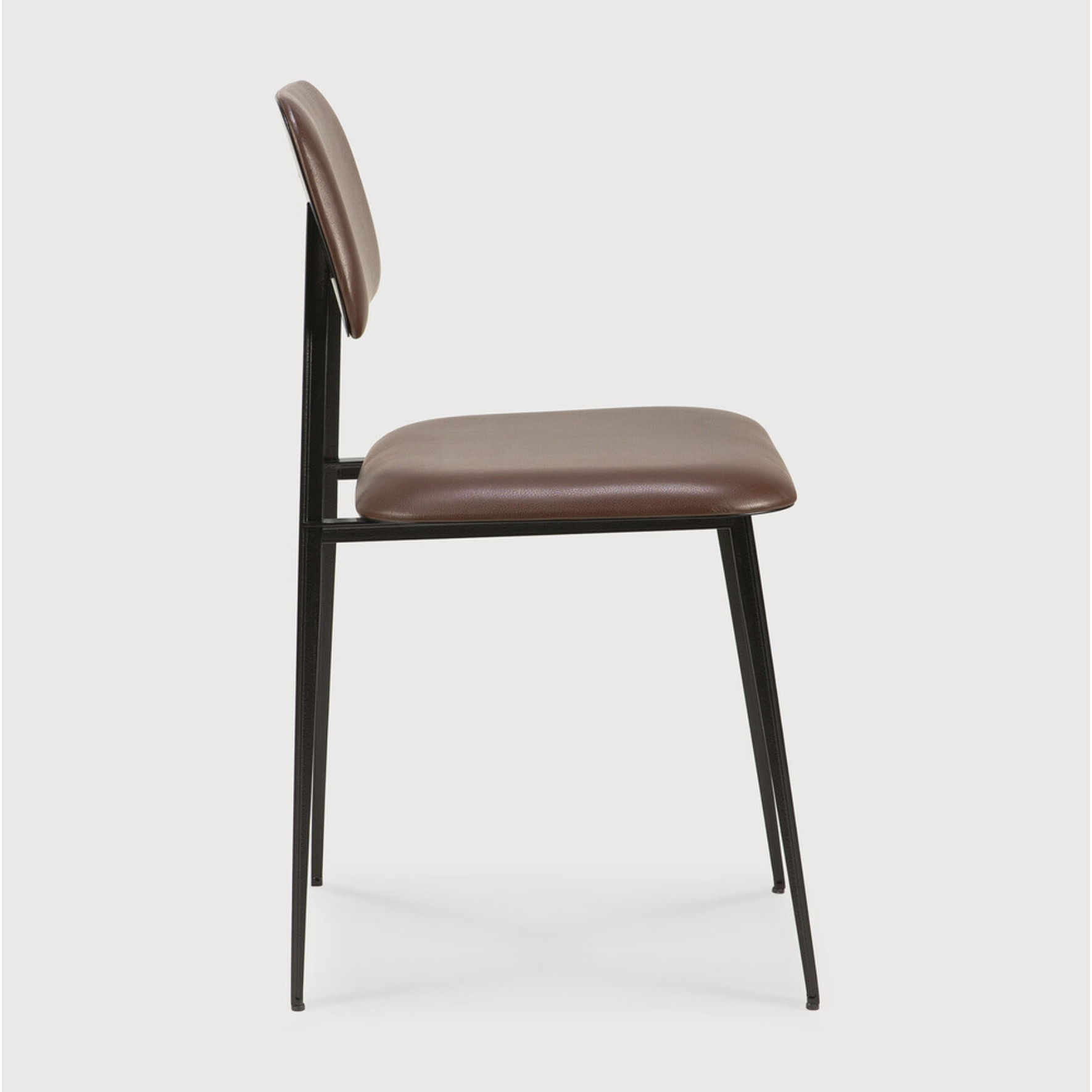 This DC Dining Chair is beautiful, minimalistic metal silhouette that would add an air of elegance to your dining table or kitchen. We love the details of the angled metal and the simplicity of this stunning chair.  Dimensions: 17"w x 19"d x 32.5"h  Weight: 19 lbs  Seat Height: 20"  Material: Metal Finish: Chocolate Leather Upholstery