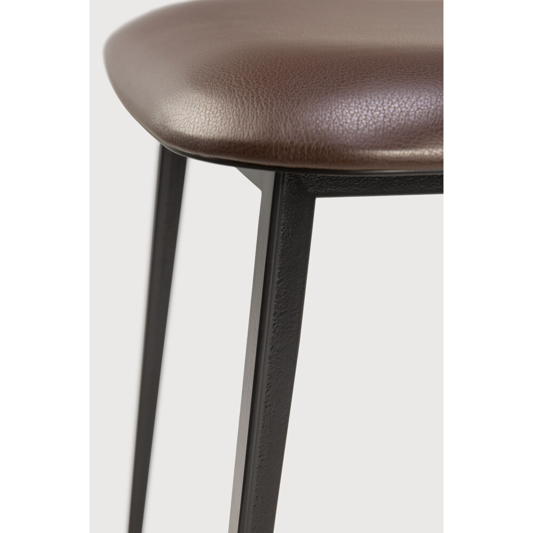 This DC Dining Chair is beautiful, minimalistic metal silhouette that would add an air of elegance to your dining table or kitchen. We love the details of the angled metal and the simplicity of this stunning chair.  Dimensions: 17"w x 19"d x 32.5"h  Weight: 19 lbs  Seat Height: 20"  Material: Metal Finish: Chocolate Leather Upholstery