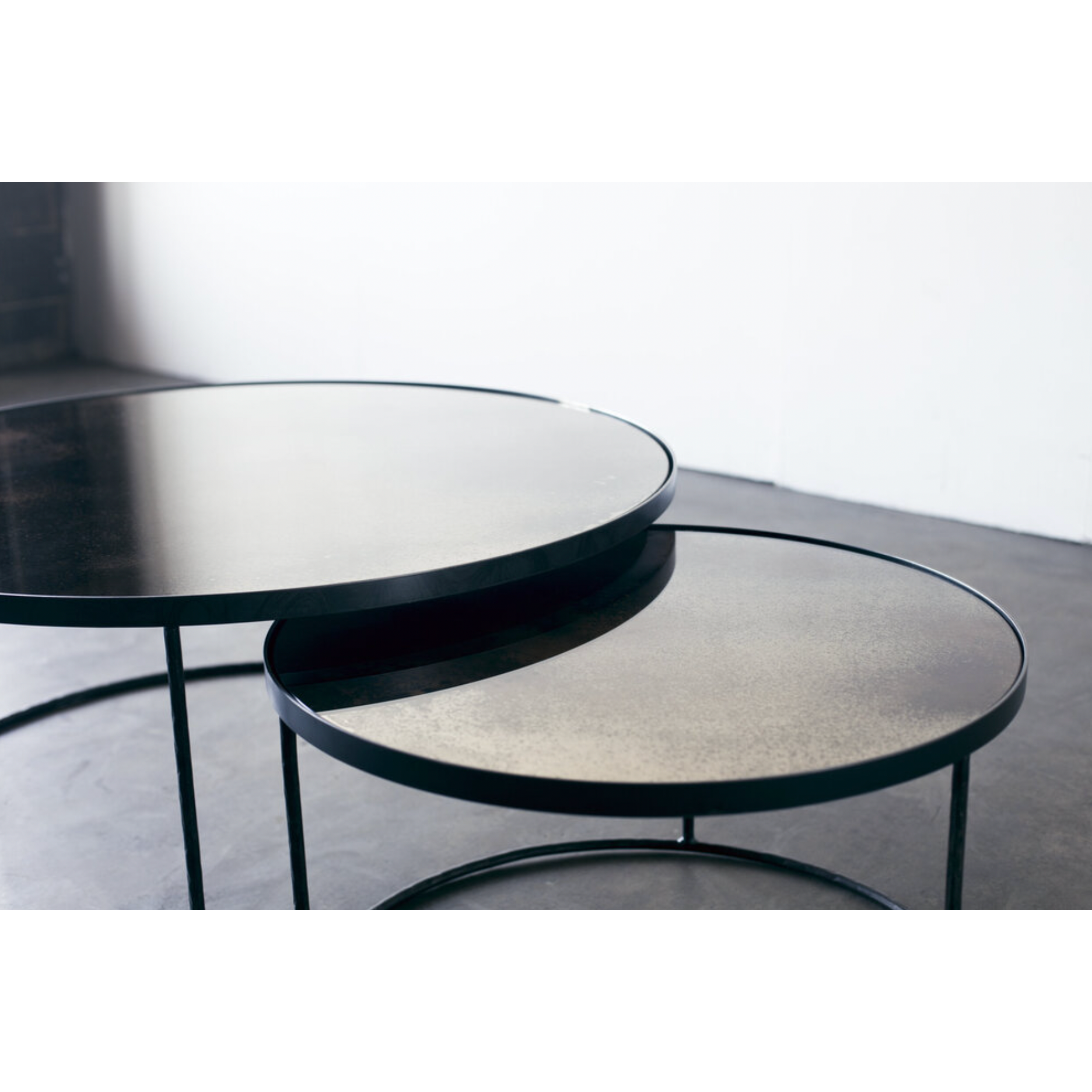 Featuring a heavy aged mirror surface, this Nesting Coffee Table Set - Clear brings a vintage look with a modern twist to any living room or lounge area.   Dimensions: 36.5"w x 36.5"d x 16.5"h  Weight: 58 lbs  Material: Mirror