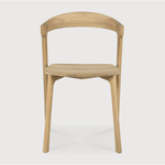 This Oak Bok Dining Chair features an airy shape with rock-solid construction,  making this piece a timeless and remarkable design to enjoy for years to come. Pair with a dining table or stand-alone against a wall, hallway, or end of the bed! Designed by Alain can Havre  Dimensions: 20"w x 21.5"d x 30"h  Weight: 20 lbs  Seat Height: 18"  Material: Oak, 100% solid wood Finish: Oiled