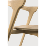 This Oak Bok Dining Chair features an airy shape with rock-solid construction,  making this piece a timeless and remarkable design to enjoy for years to come. Pair with a dining table or stand-alone against a wall, hallway, or end of the bed! Designed by Alain can Havre  Dimensions: 20"w x 21.5"d x 30"h  Weight: 20 lbs  Seat Height: 18"  Material: Oak, 100% solid wood Finish: Oiled