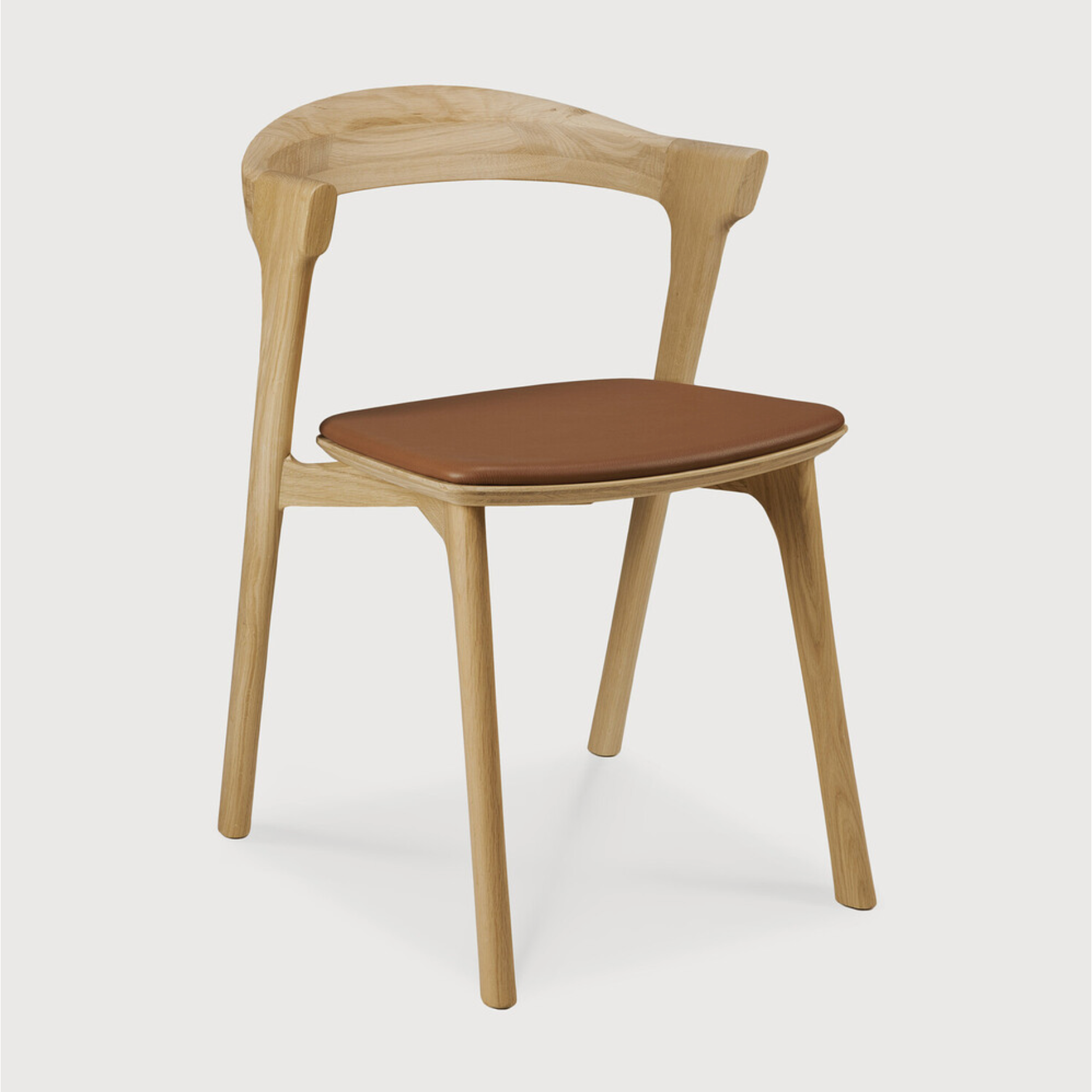 This Oak Bok Dining Chair features an airy shape with rock-solid construction,  making this piece a timeless and remarkable design to enjoy for years to come. Pair with a dining table or stand-alone against a wall, hallway, or end of the bed! Designed by Alain can Havre  Dimensions: 20"w x 21.5"d x 30"h  Weight: 15 lbs  Seat Height: 19"  Material: Oak, 100% solid wood Finish: Varnished