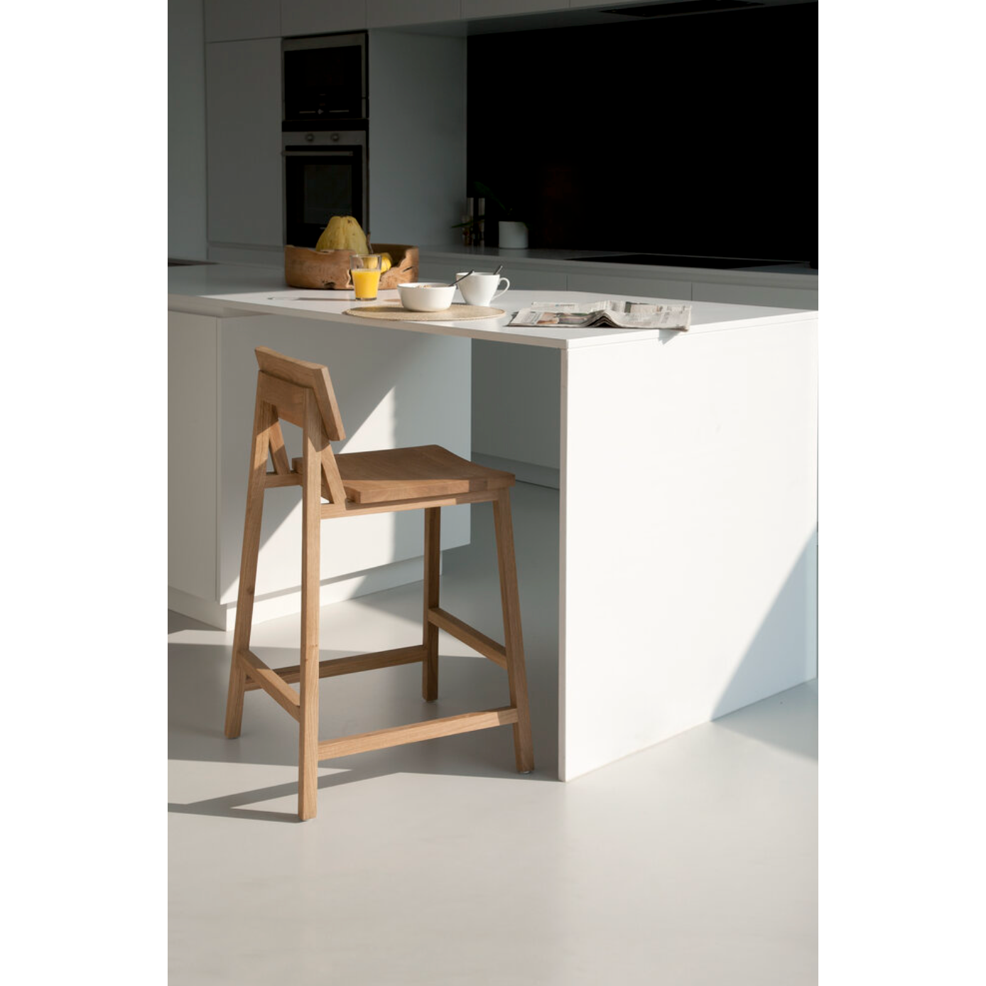 We love the versatility of this Oak N3 counter stool. Designed by Nathan Yong, this stool is a timeless piece that adds both modern lines and a cozy organic aesthetic to your bar area or kitchen island.  Dimensions: 19.5"w x 20"d x 36"h Seat Height: 26"  Material: Oak, 100% Solid Wood Finish: Oiled 