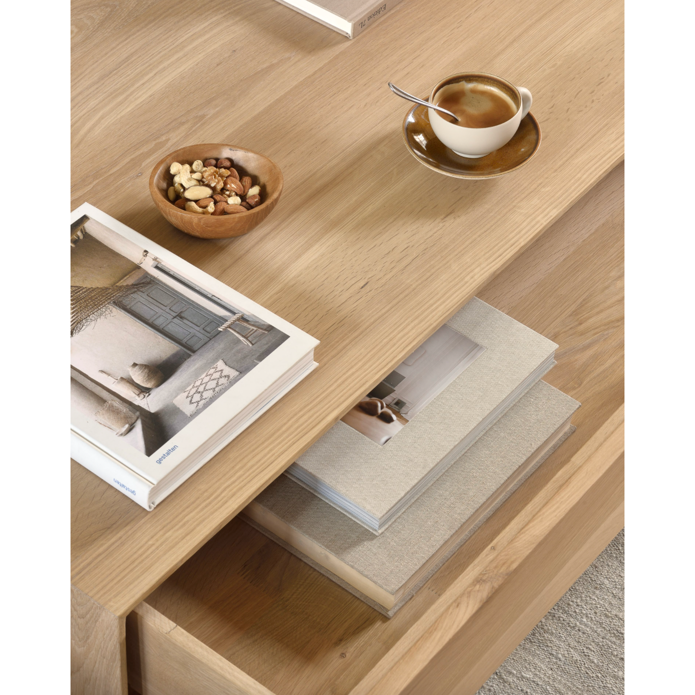 Featuring both a bottom shelf and a drawer, this Oak Nordic Coffee Table brings a functional and beautiful organic element to any living room or lounge area.   Dimensions: 47.5"w x 28"d x 14"h  Weight: 112 lbs  Material: Oak, 100% solid wood Finish: Oiled