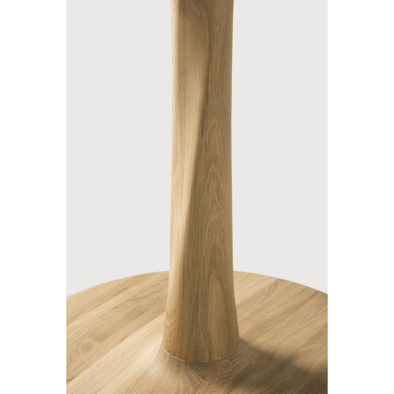 Airy with subtle complexities, this Oak Round Torsion Dining Table incorporates advanced woodworking techniques to create a light table top with a torsaded base of sculptural elegance -- sure to elevate the look for any dining or kitchen area.   Material: Oak, 100% Solid Wood Finish: Varnished
