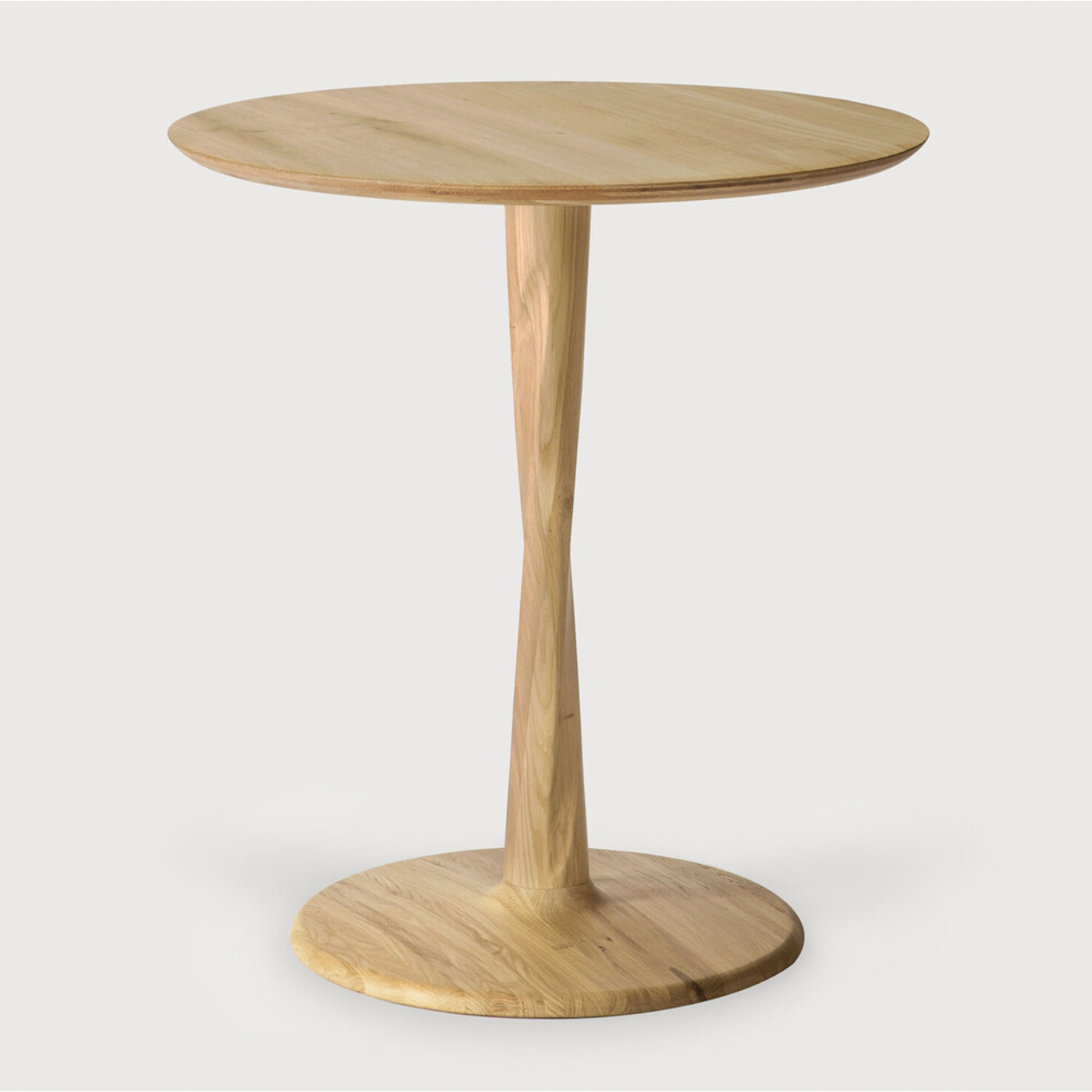 Airy with subtle complexities, this Oak Round Torsion Dining Table incorporates advanced woodworking techniques to create a light table top with a torsaded base of sculptural elegance -- sure to elevate the look for any dining or kitchen area.   Material: Oak, 100% Solid Wood Finish: Varnished
