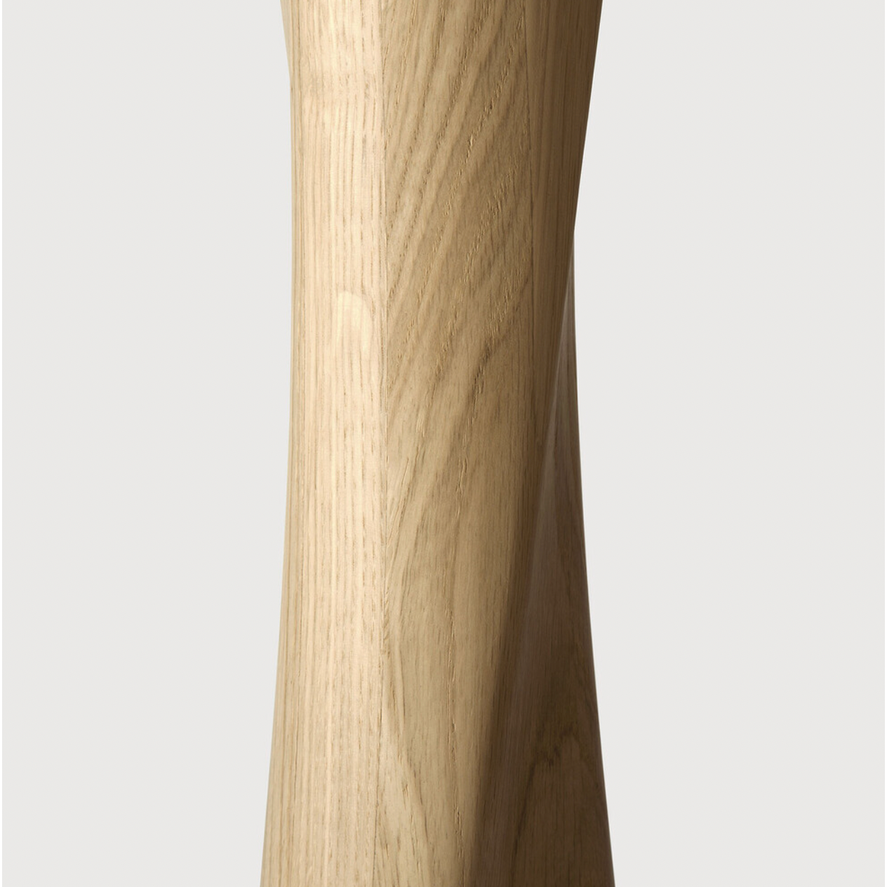 Airy with subtle complexities, this Oak Round Torsion Dining Table incorporates advanced woodworking techniques to create a light table top with a torsaded base of sculptural elegance -- sure to elevate the look for any dining or kitchen area.   Material: Oak, 100% Solid Wood Finish: Varnished