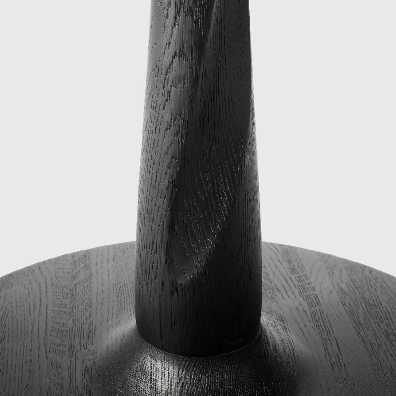 We love the modern, sleek look of this Oak Torsion 28" Dining Table - Black. The varnish finish gives more depth, with the rougher surface highlighting the grain of the wood.  Dimensions: 28"w x 28"d x 30"h  Material: Oak  Finish: Varnished